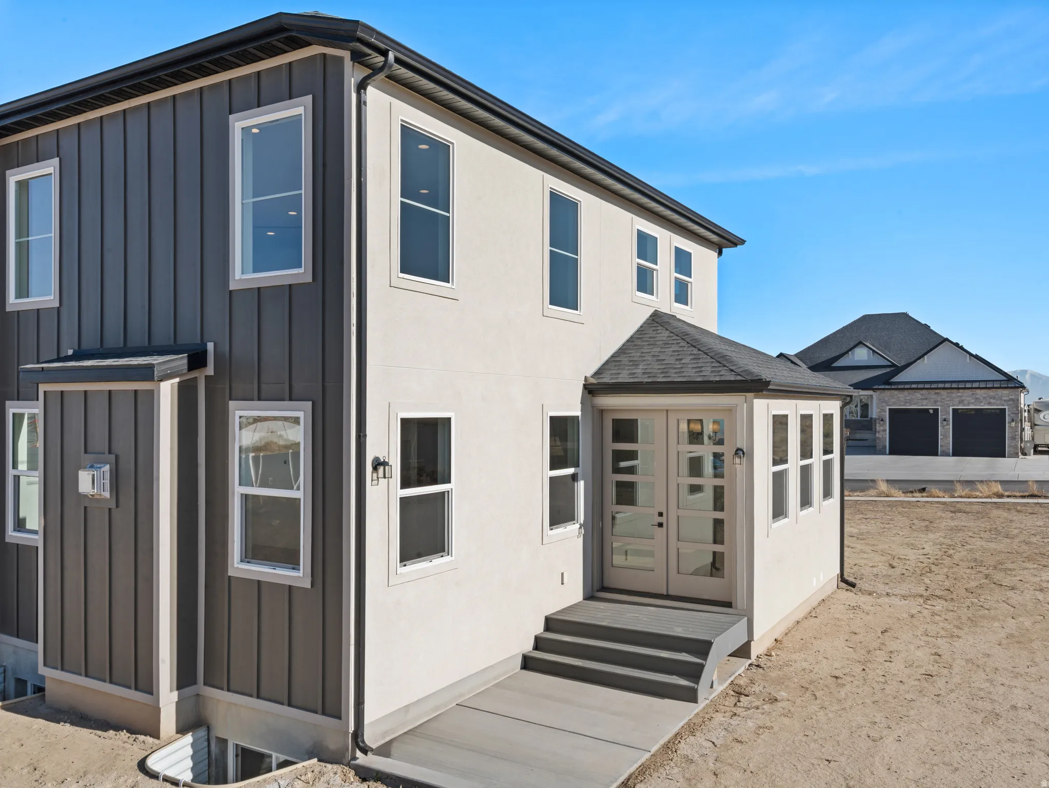 View of front facade with board and batten siding and roof with shingles