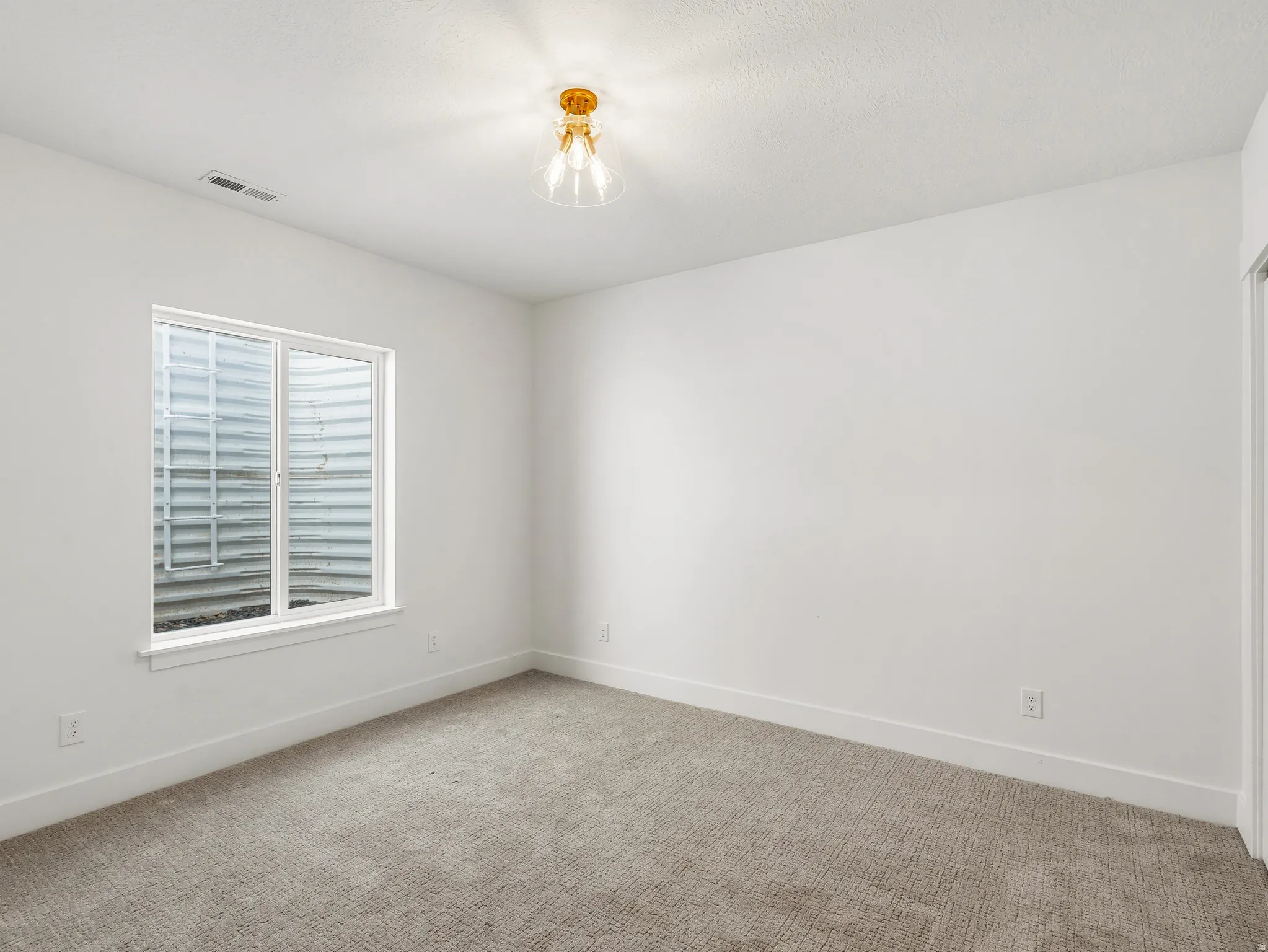 Spare room with carpet flooring and baseboards