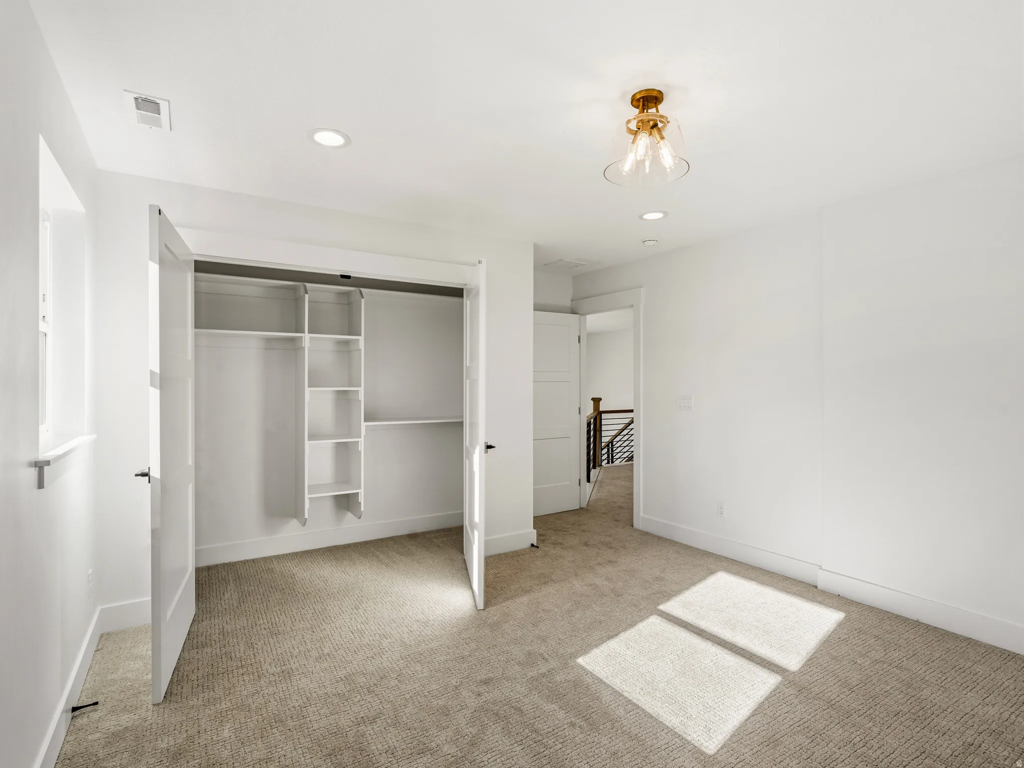 Upstairs bedroom with recessed lighting, a closet, and light colored carpet