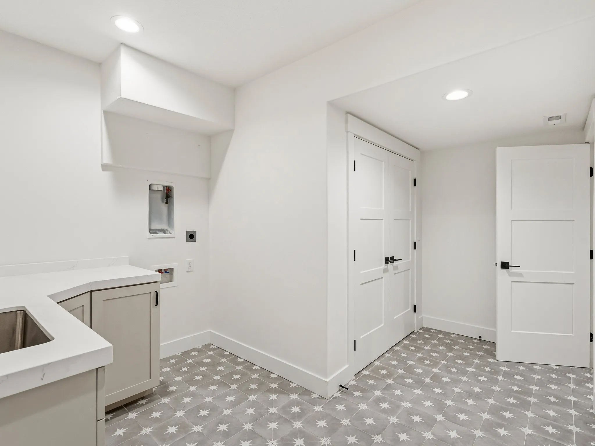 Laundry room featuring light floors, cabinet space, recessed lighting, and hookup for a washing machine