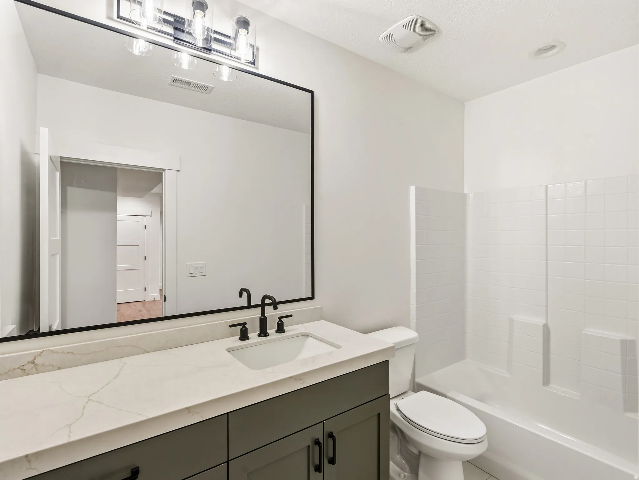 Bathroom featuring vanity and  shower combination