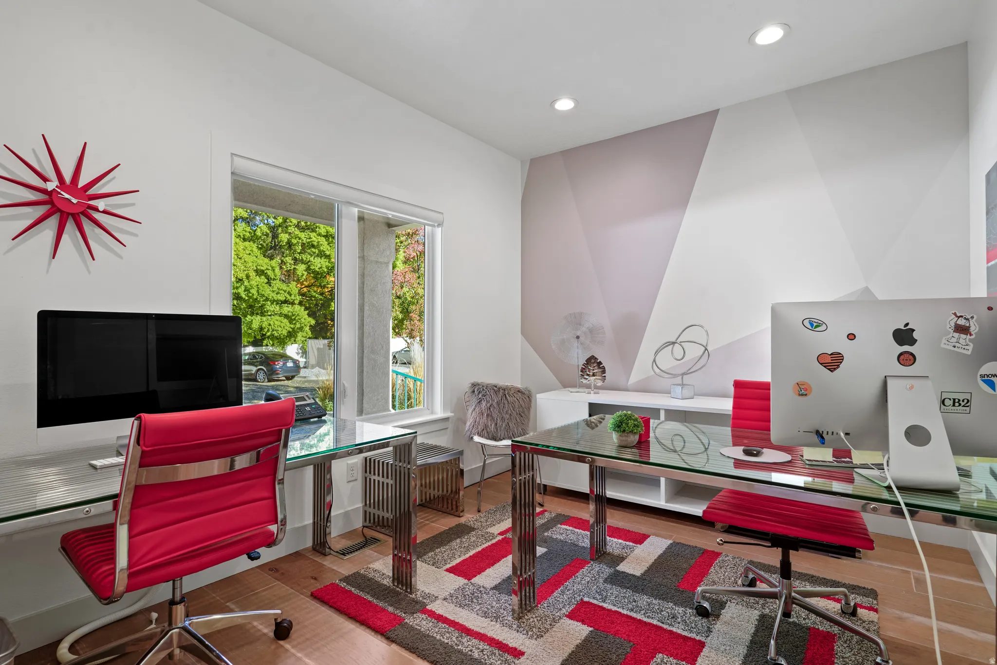 Office space with light wood finished floors and recessed lighting