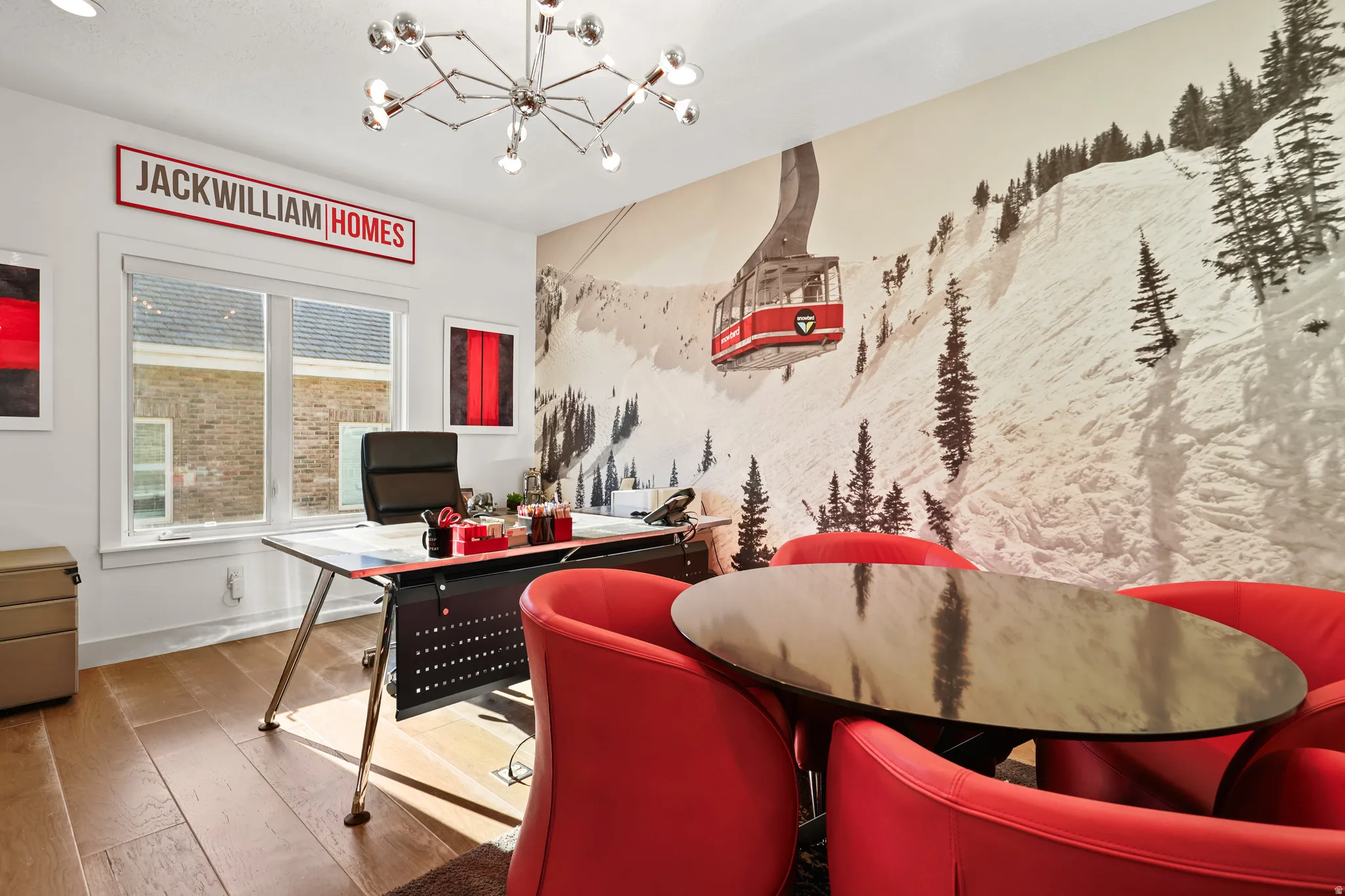 Home office with hardwood / wood-style flooring and a chandelier