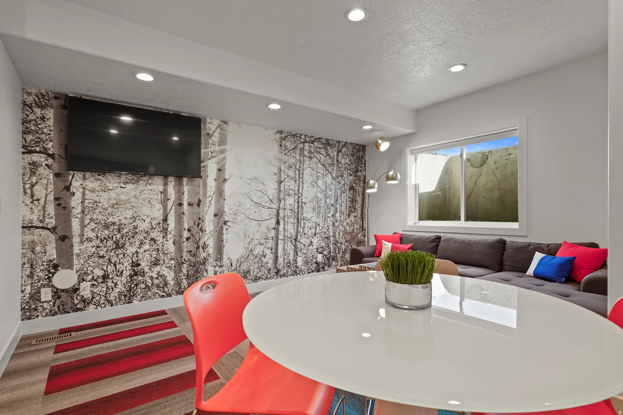 Dining area featuring recessed lighting, a textured ceiling, and an accent wall