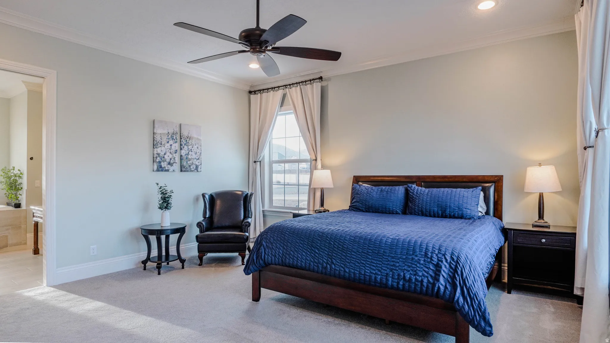 Bedroom featuring crown molding, light colored carpet, recessed lighting, ceiling fan, and ensuite bath