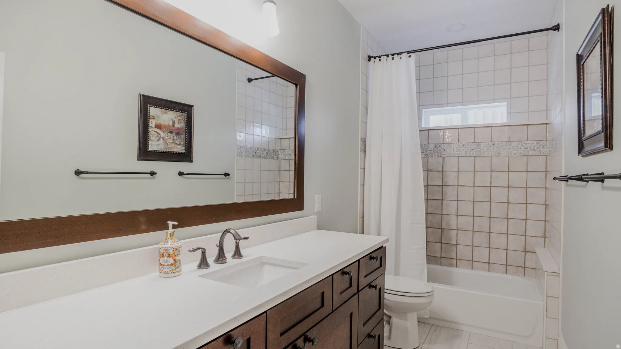 Bathroom featuring shower / tub combo and vanity