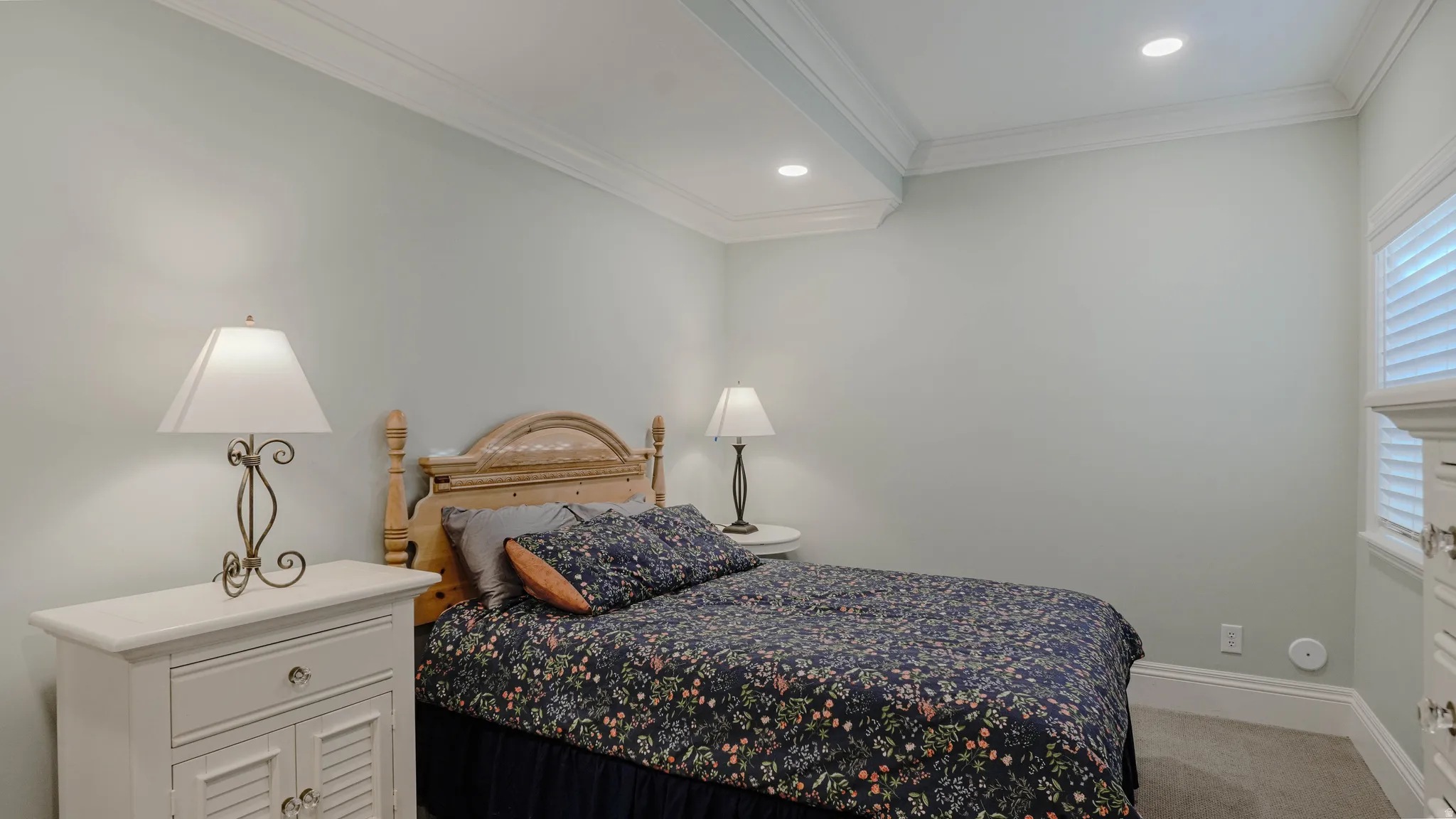 Bedroom with ornamental molding, light colored carpet, and recessed lighting