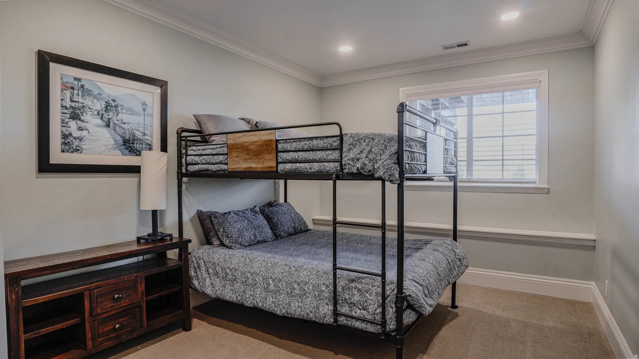 Bedroom featuring light carpet and ornamental molding