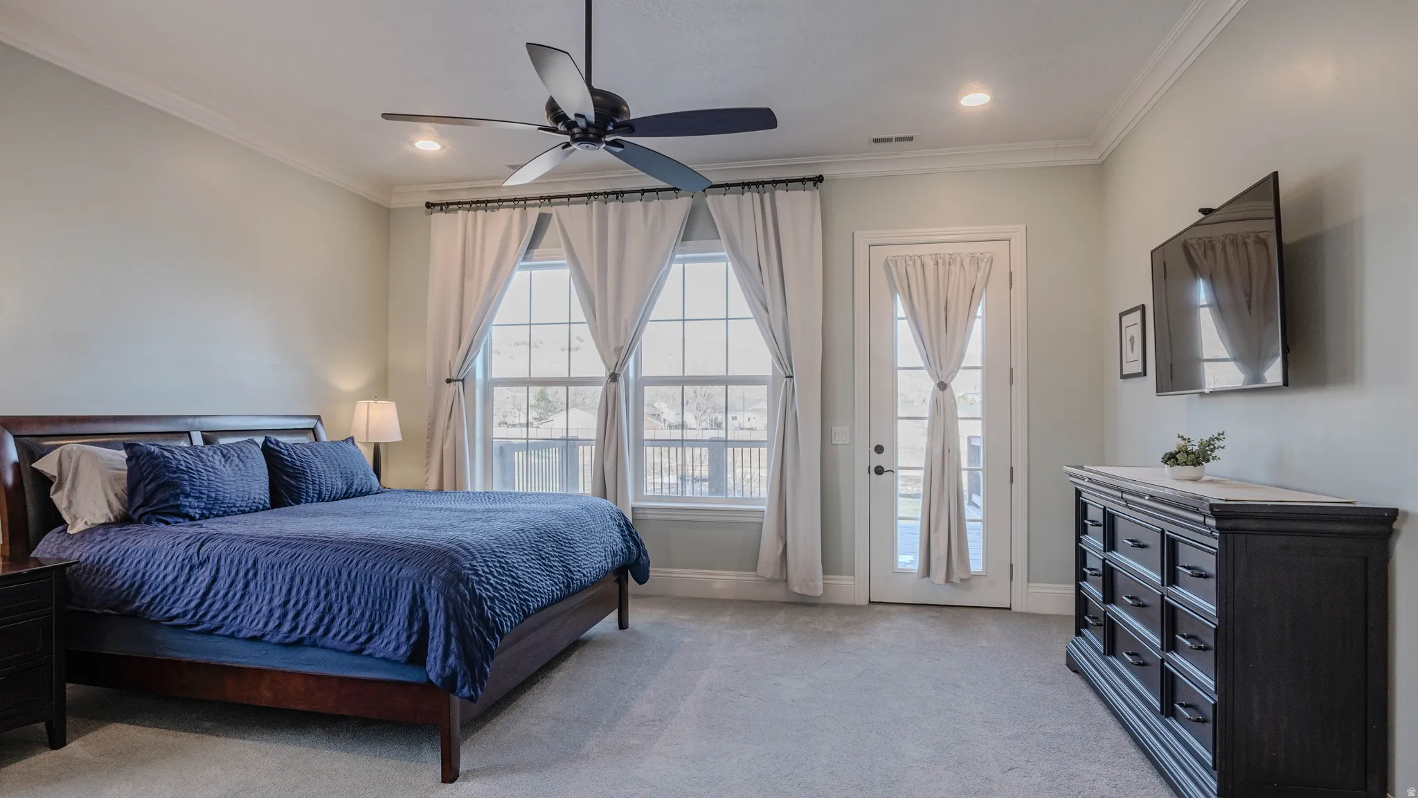 Bedroom with light carpet, crown molding, access to exterior, ceiling fan, and recessed lighting