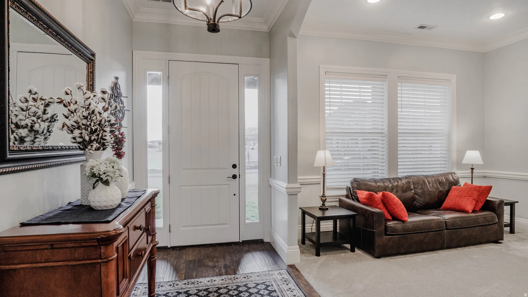 Entrance foyer and Formal Living room featuring ornamental molding, finished tile floors, a chandelier, and recessed lighting