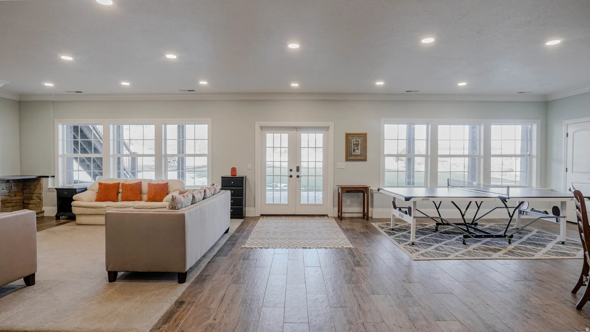 Living area featuring tile floors, recessed lighting, and french doors