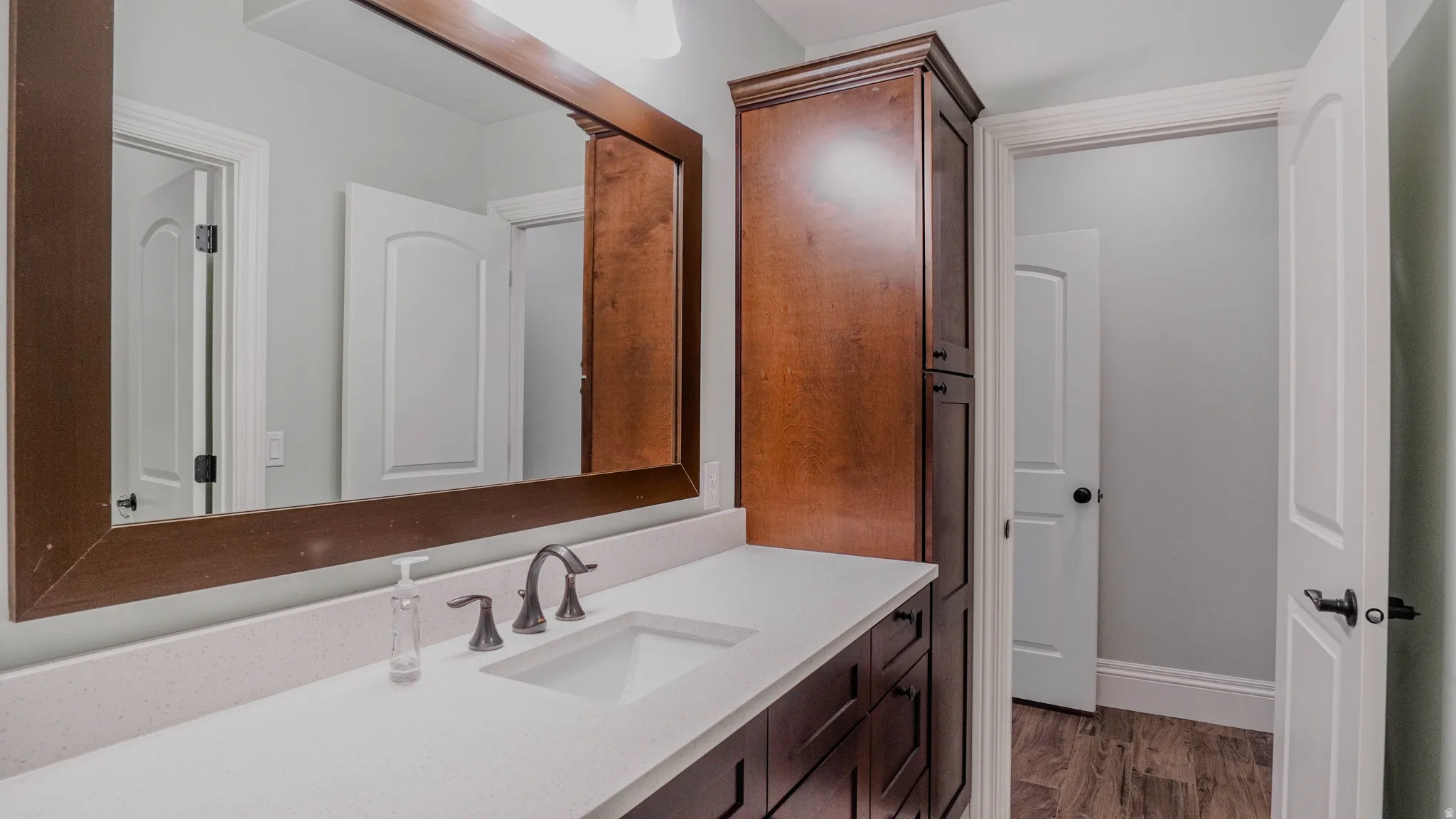 Bathroom with vanity and dark wood finished floors