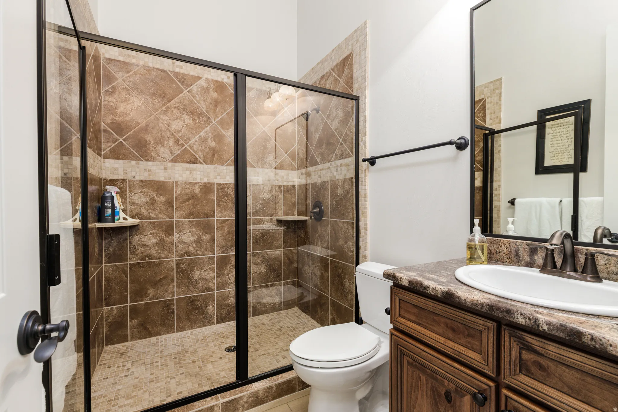 Bathroom with vanity and a stall shower