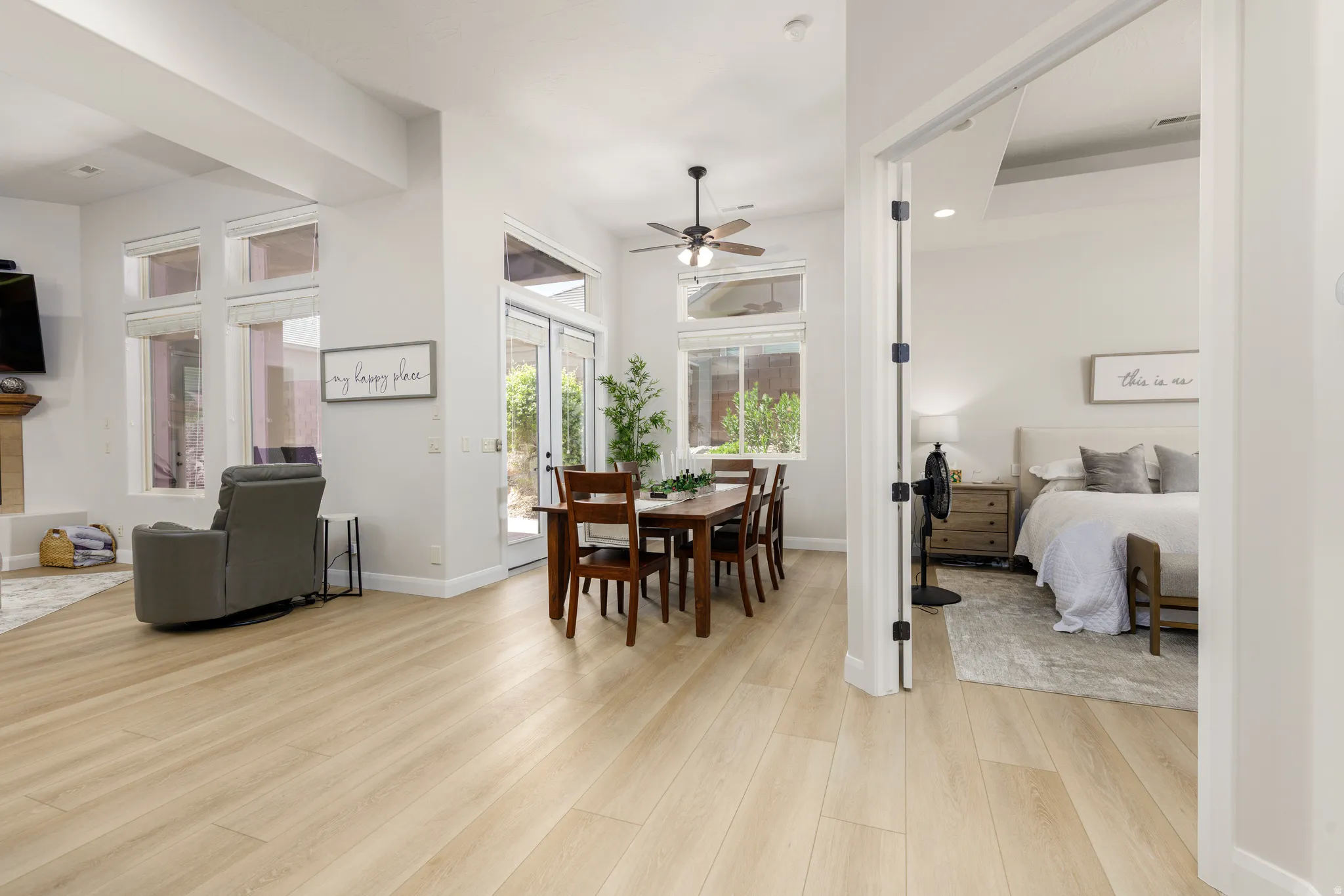 Dining area with light wood-style floors and a ceiling fan