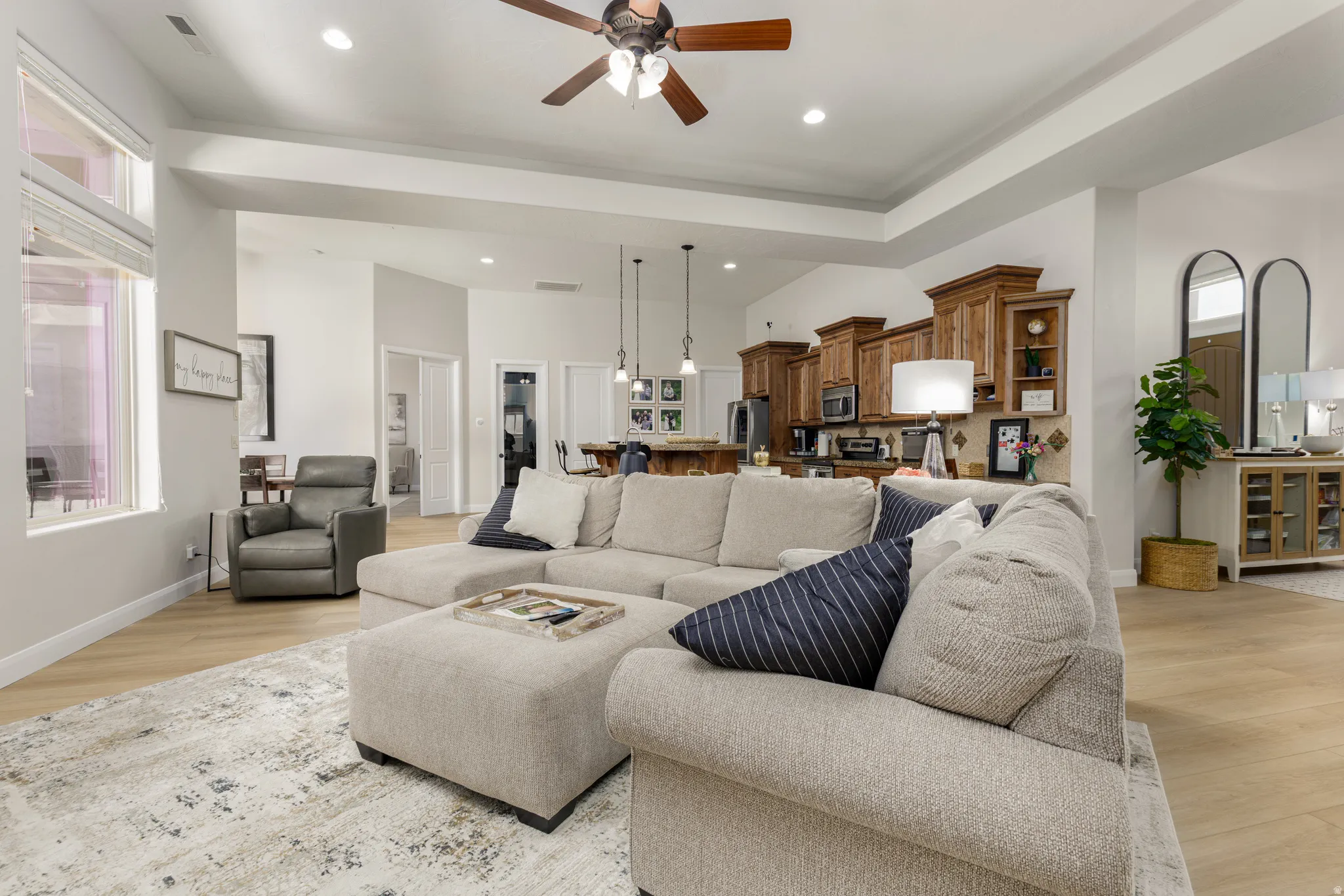 Living room featuring a ceiling fan, light wood-style floors, and recessed lighting