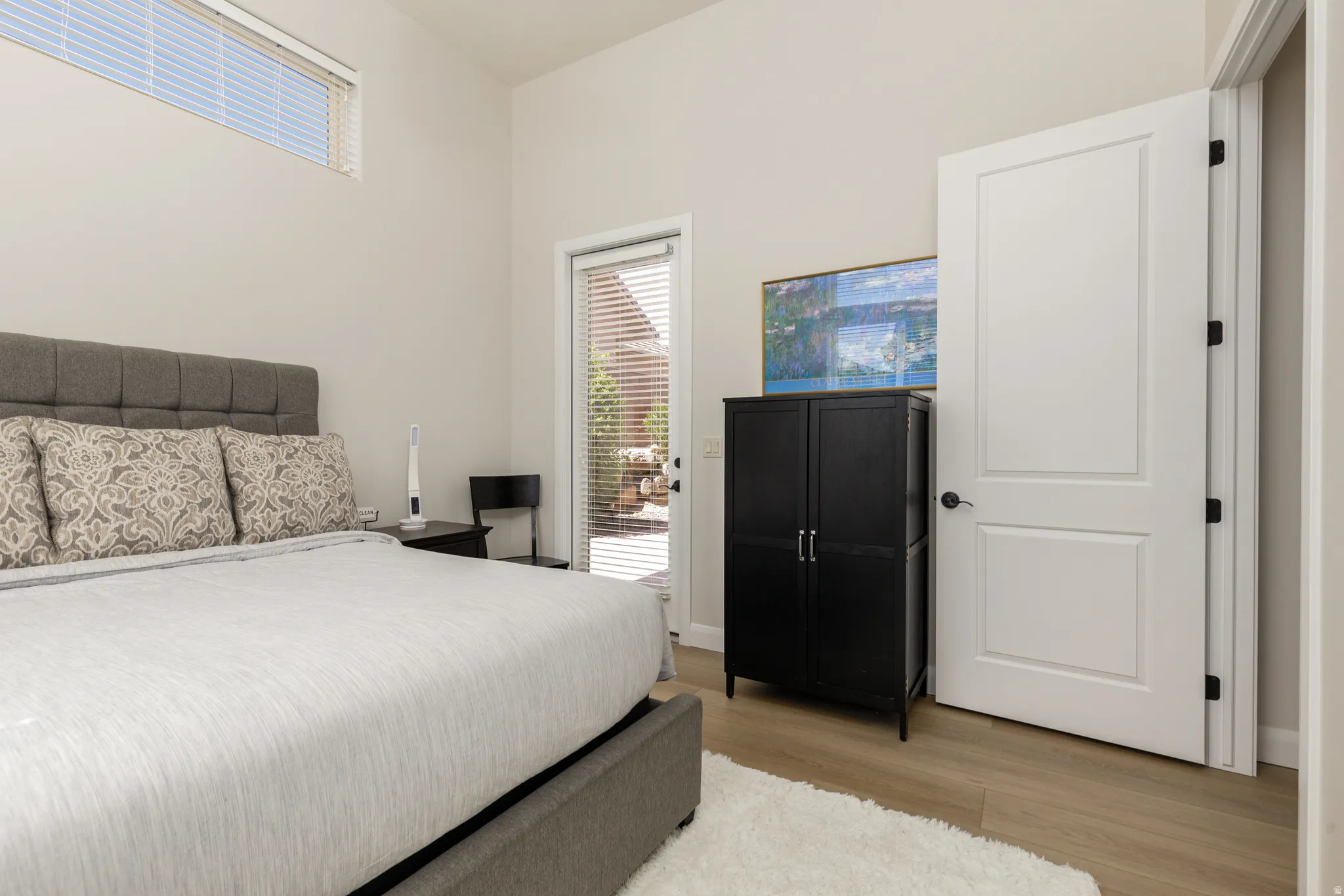 Bedroom with light wood-style floors and access to outside