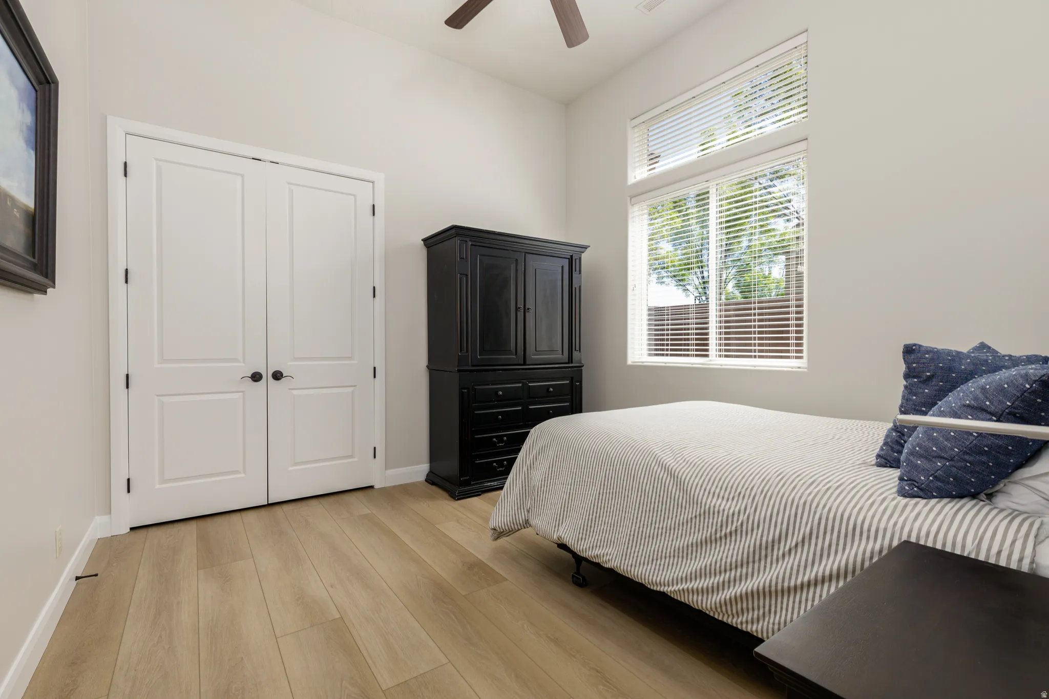 Bedroom with light wood-type flooring and a ceiling fan