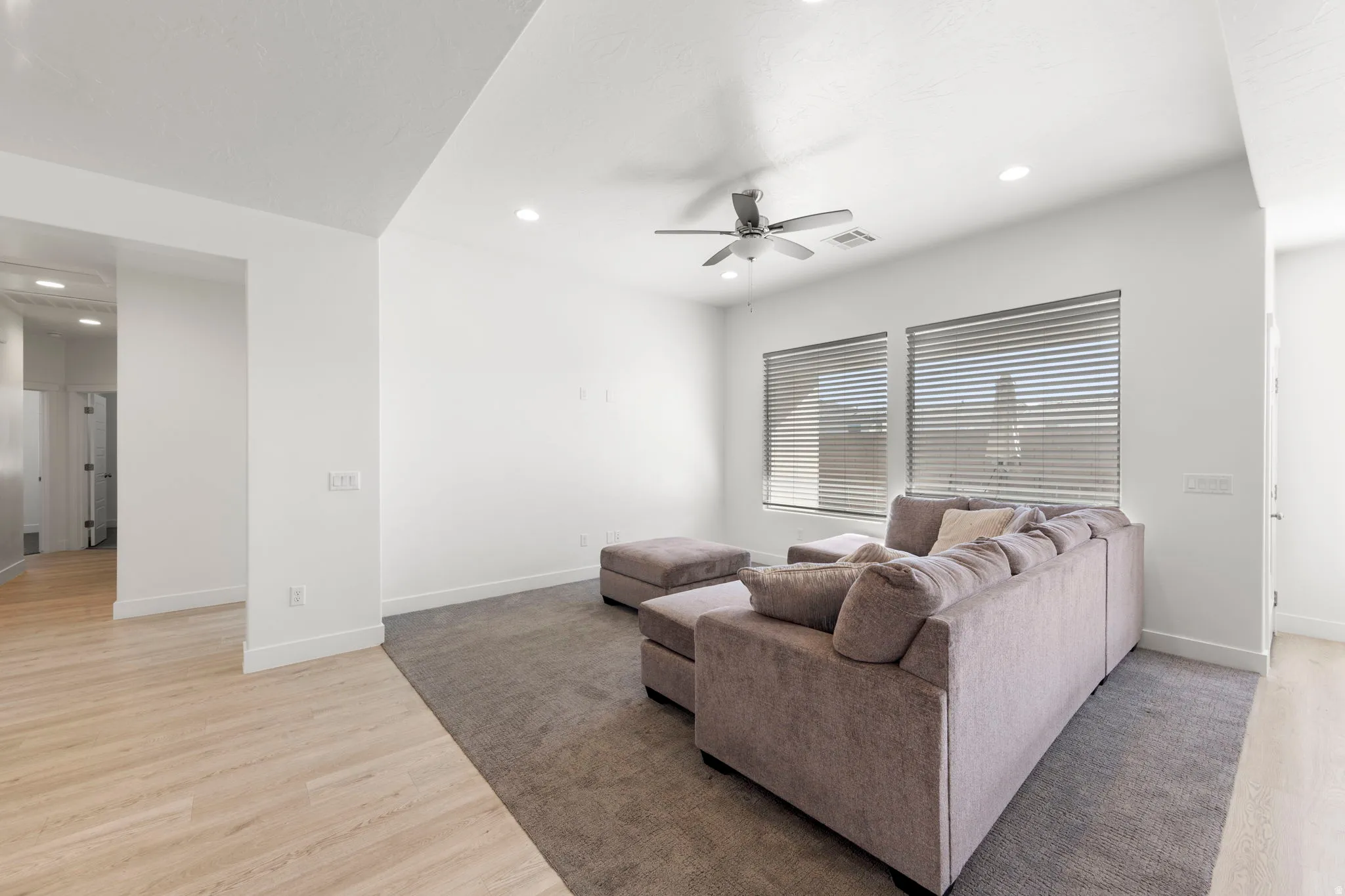 Living area featuring light wood finished floors, recessed lighting, and ceiling fan