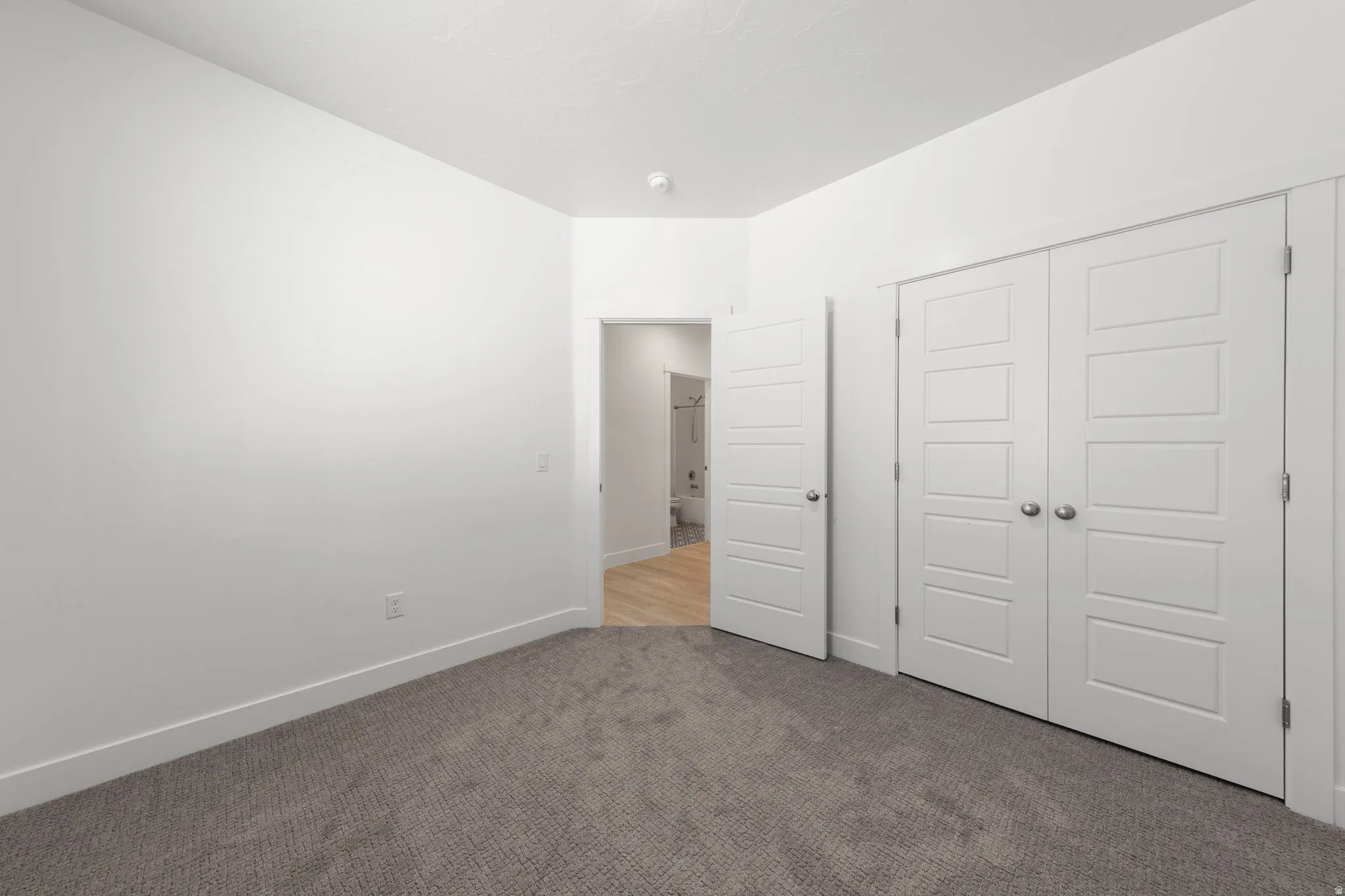 Unfurnished bedroom featuring carpet floors and a closet