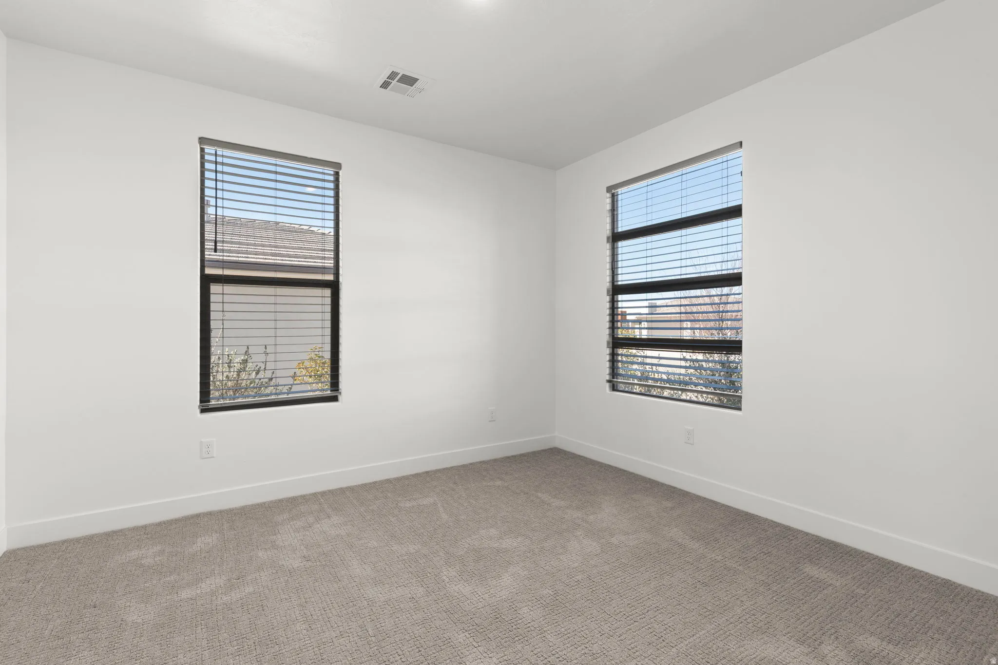 Unfurnished room with carpet and plenty of natural light