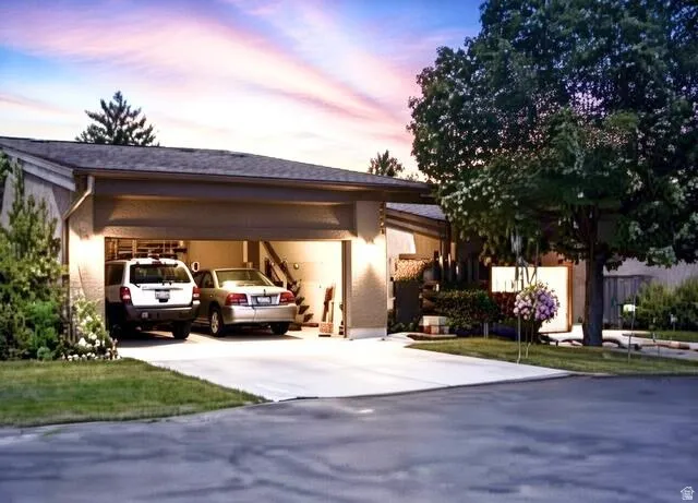View of front of house with concrete driveway and stucco siding