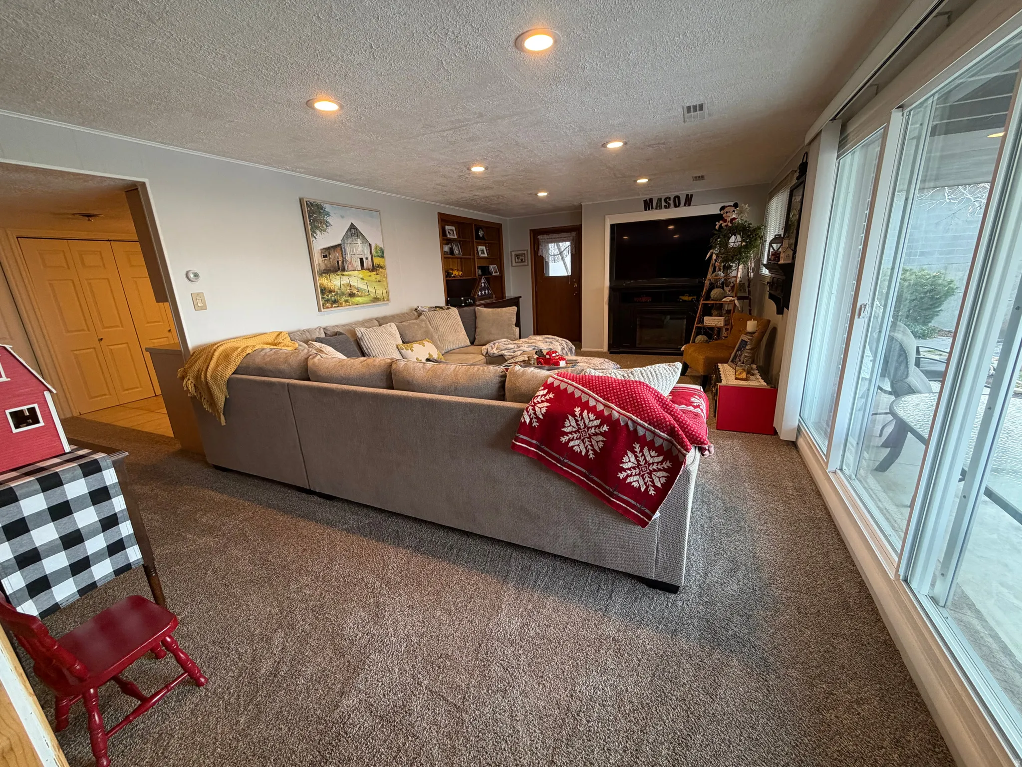 Carpeted living room featuring a textured ceiling, healthy amount of natural light, and recessed lighting