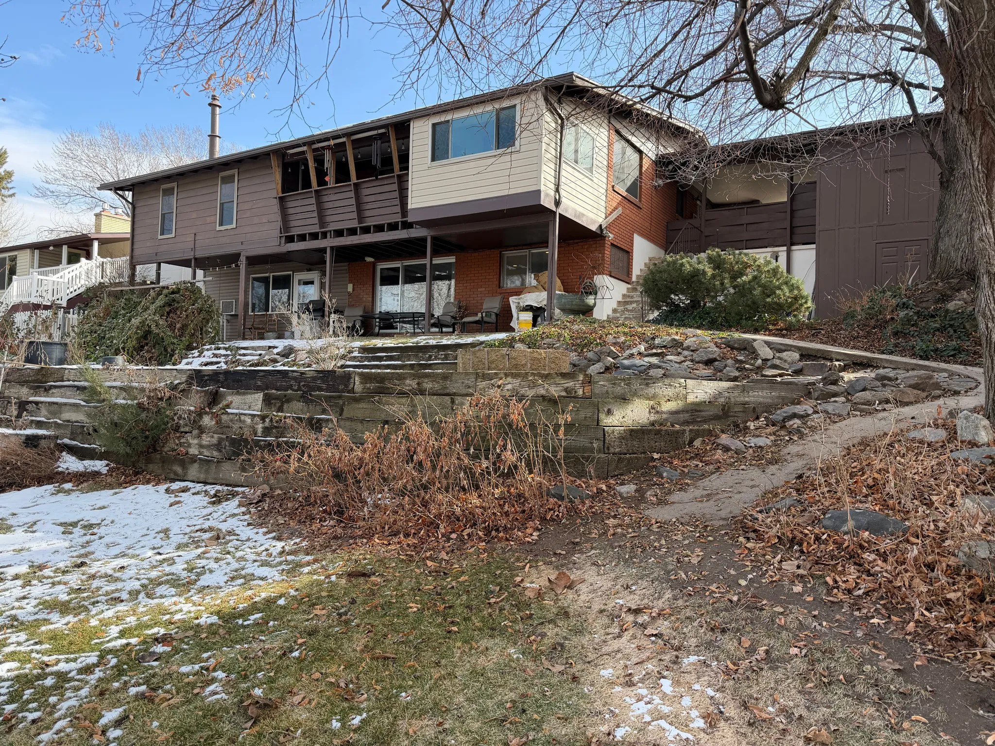 Back of house featuring a patio and brick siding
