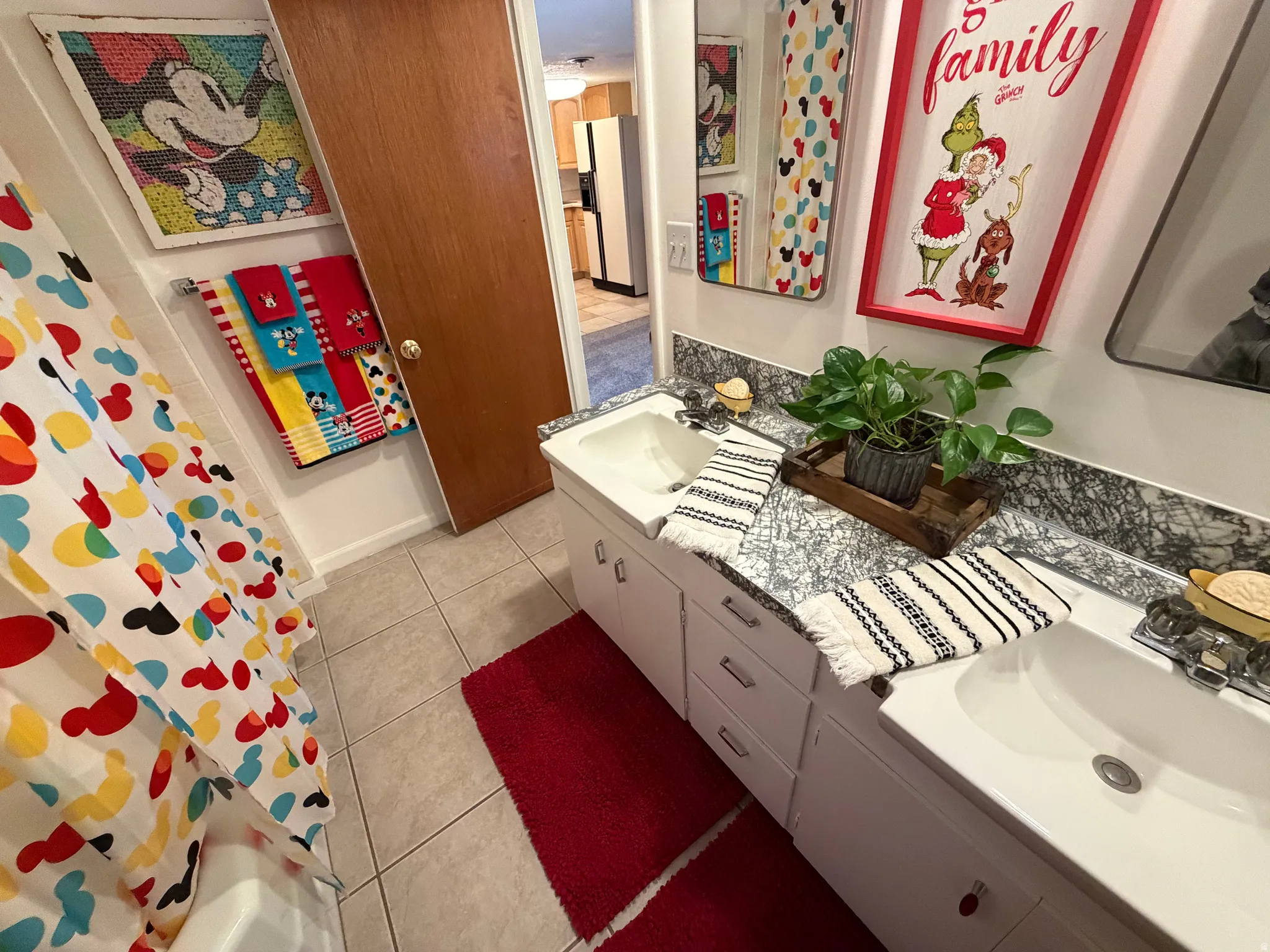 Full bathroom with double vanity and light tile patterned flooring