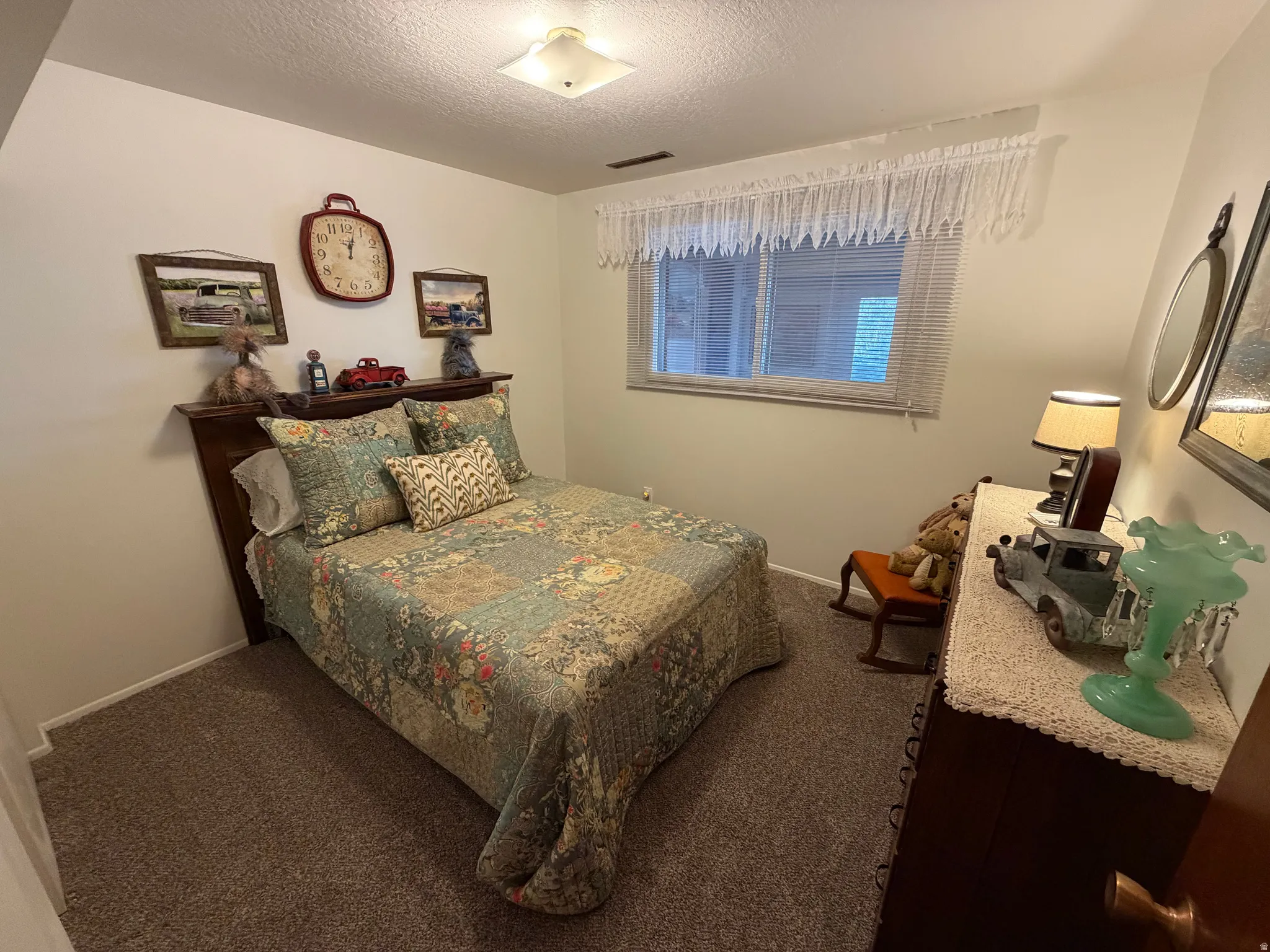 Bedroom with carpet floors and a textured ceiling
