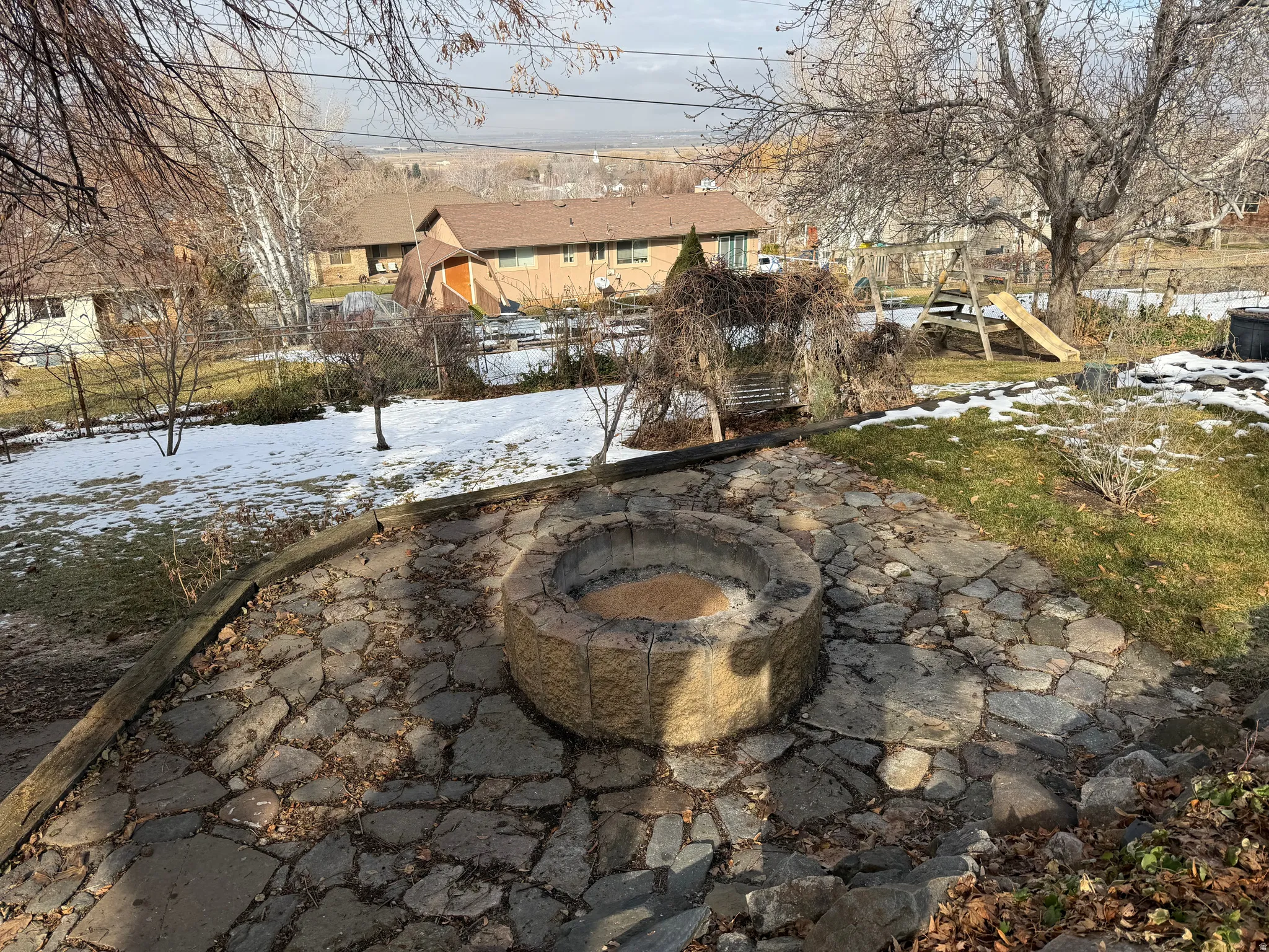 View of yard with a fire pit and a residential view