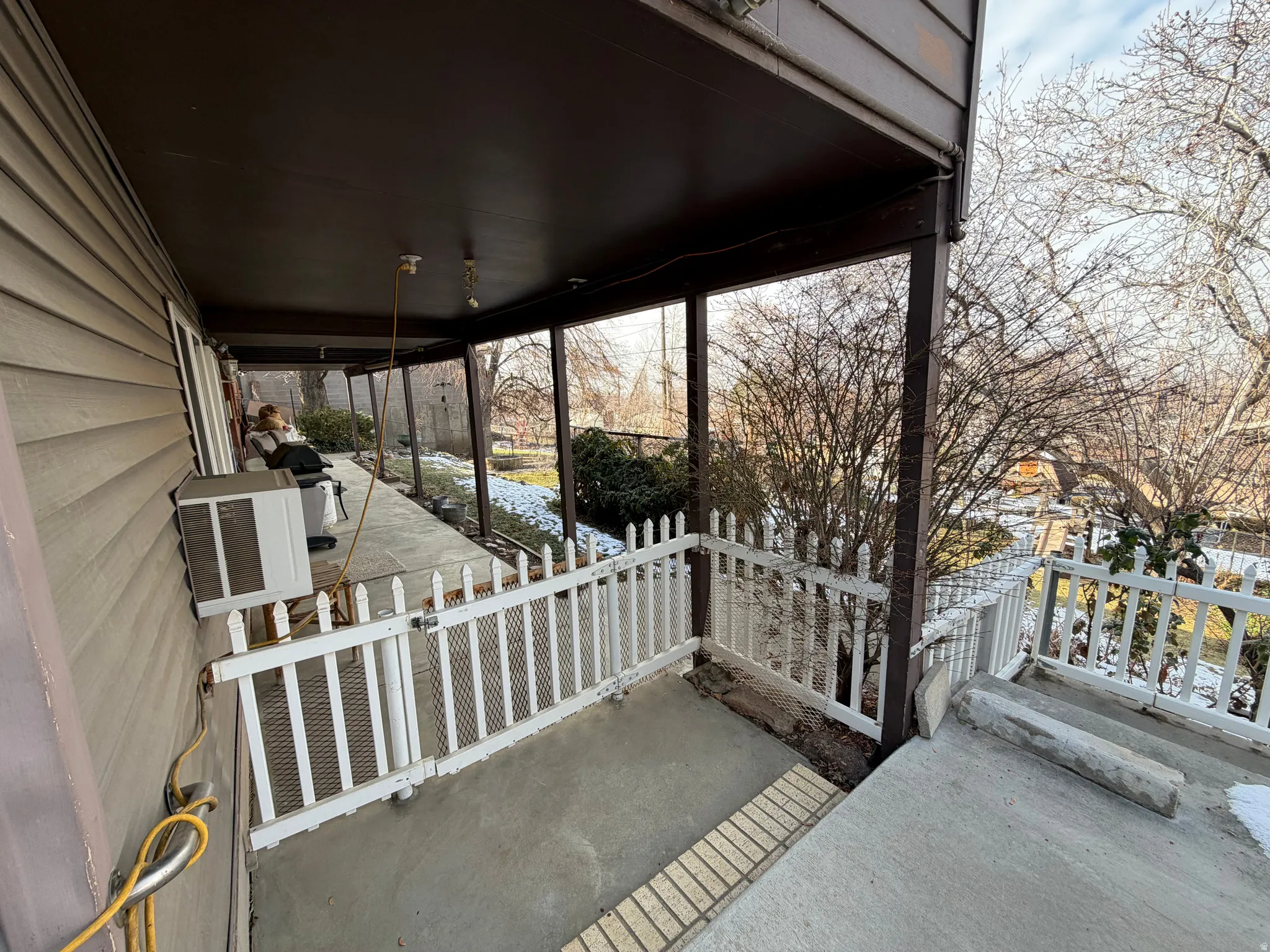 Covered porch featuring cooling unit