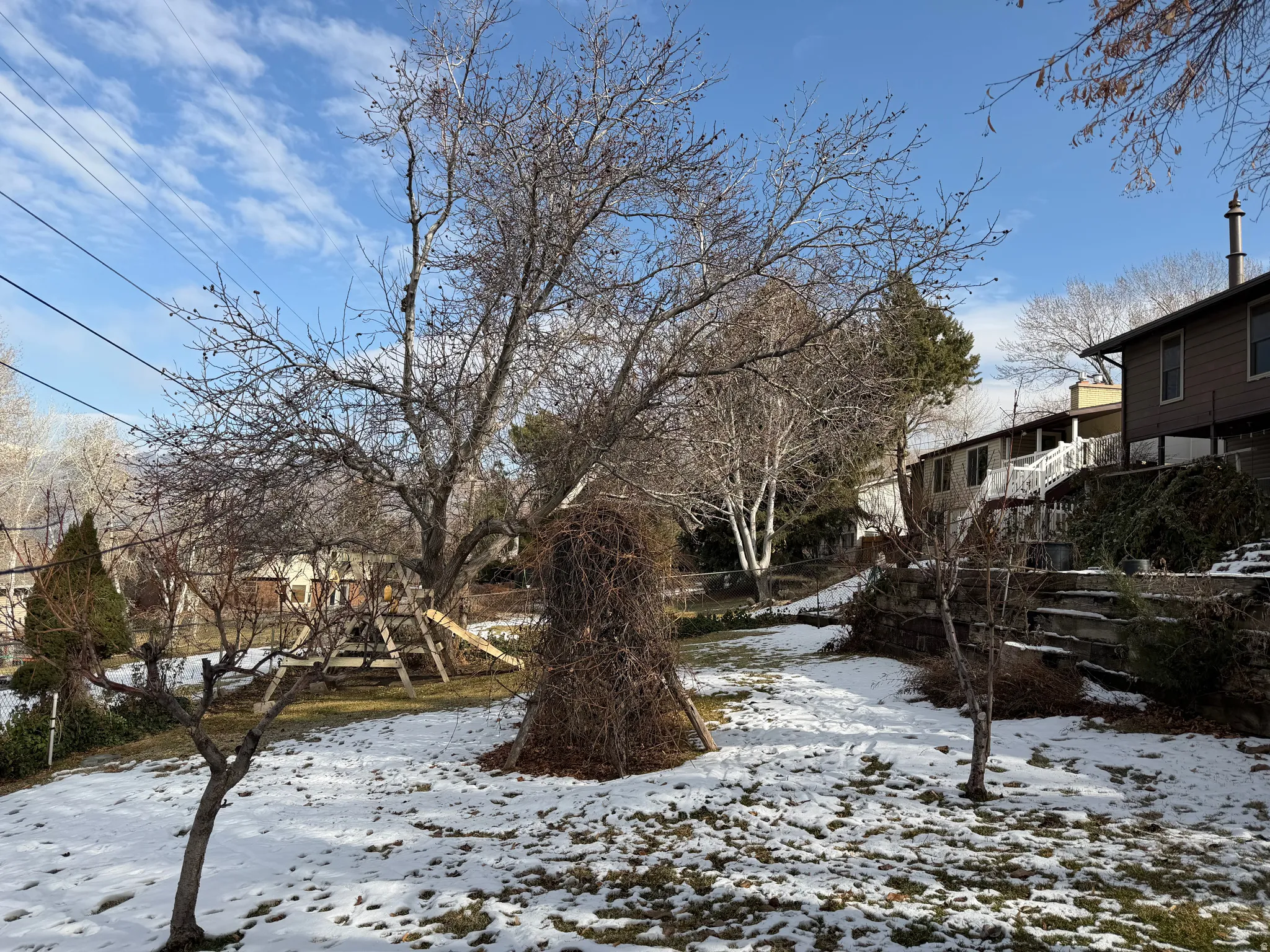 Snowy yard with a playground