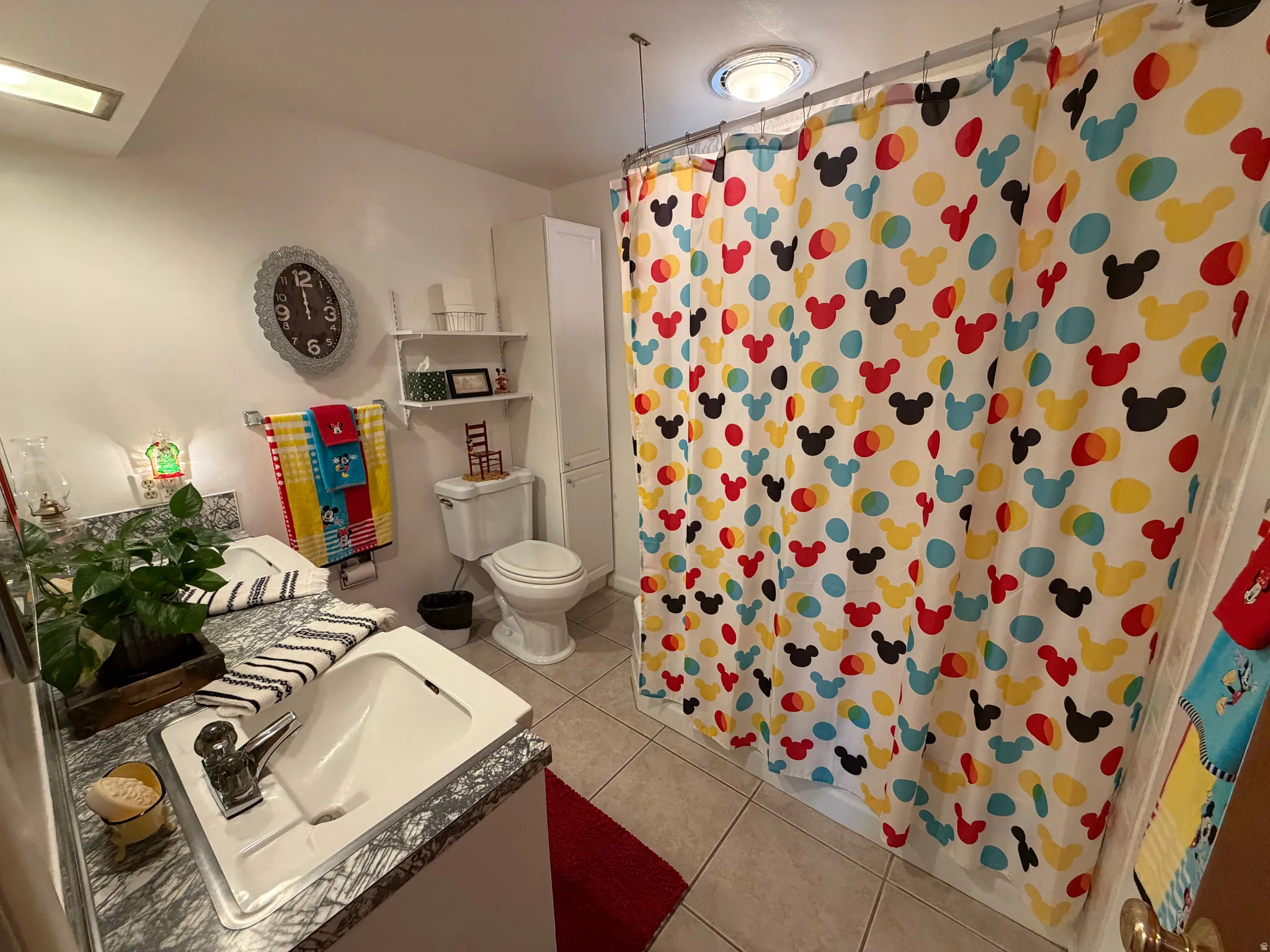 Full bath with vanity, a shower with curtain, and light tile patterned floors