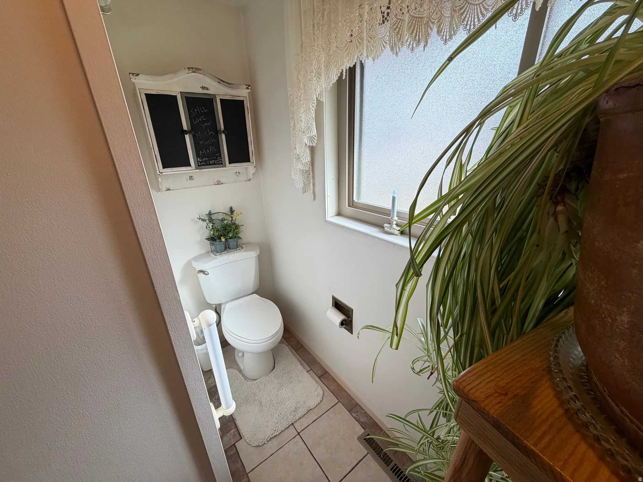 Half bathroom with toilet and tile patterned flooring