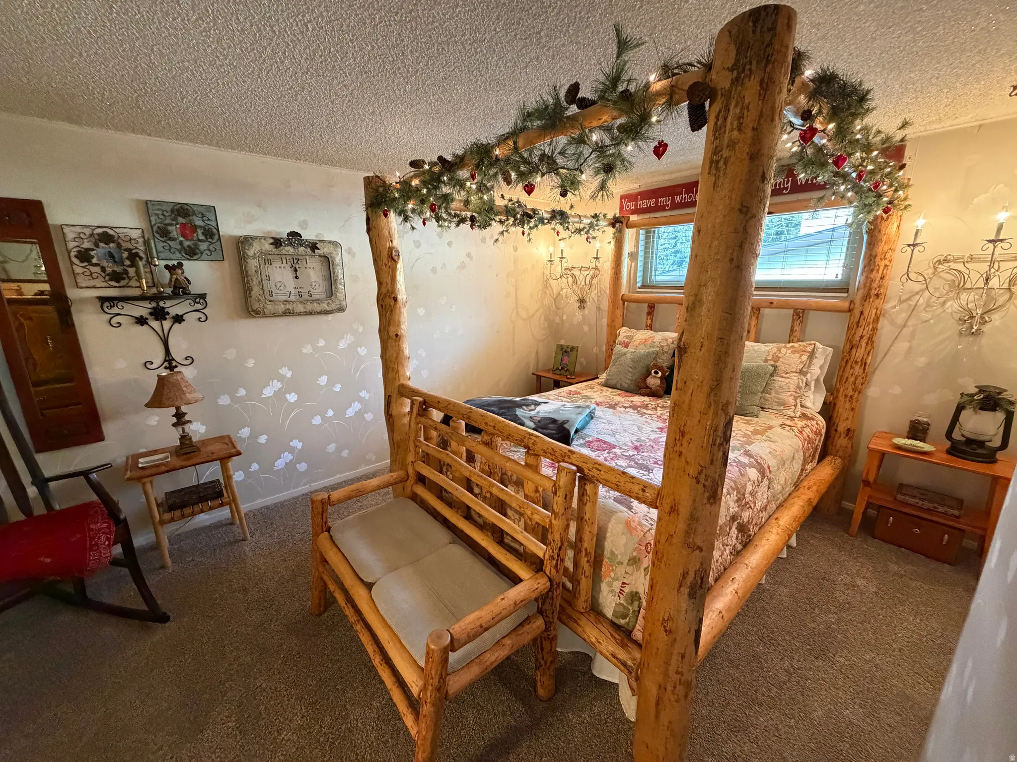 Carpeted bedroom featuring a textured ceiling and baseboards