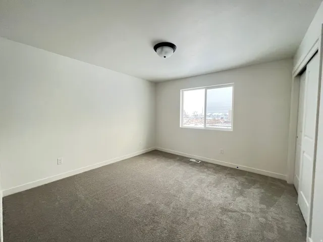 Unfurnished bedroom with carpet and a closet