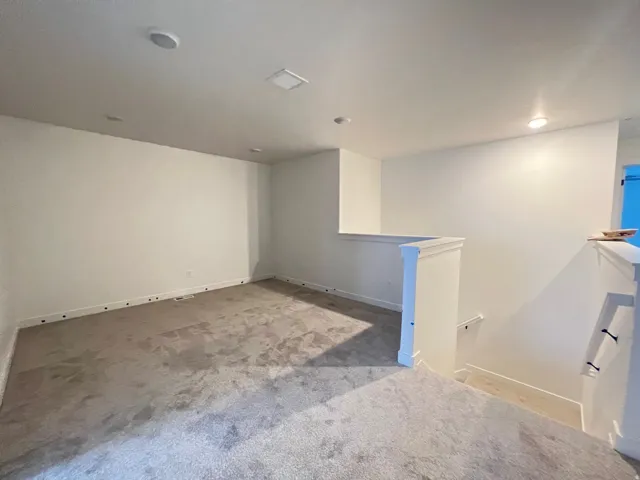 Spare room with light carpet and baseboards