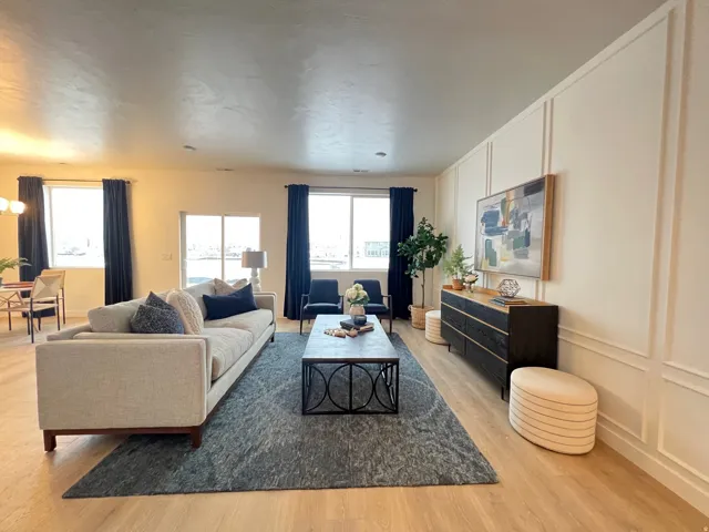 Living area with a decorative wall and light wood-type flooring