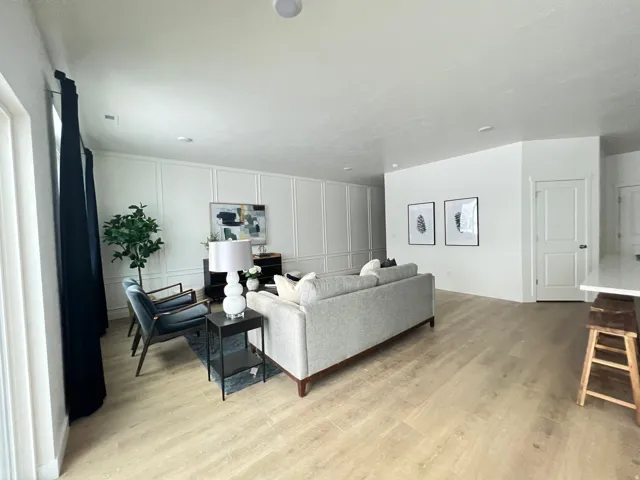 Living room with a decorative wall and light wood finished floors