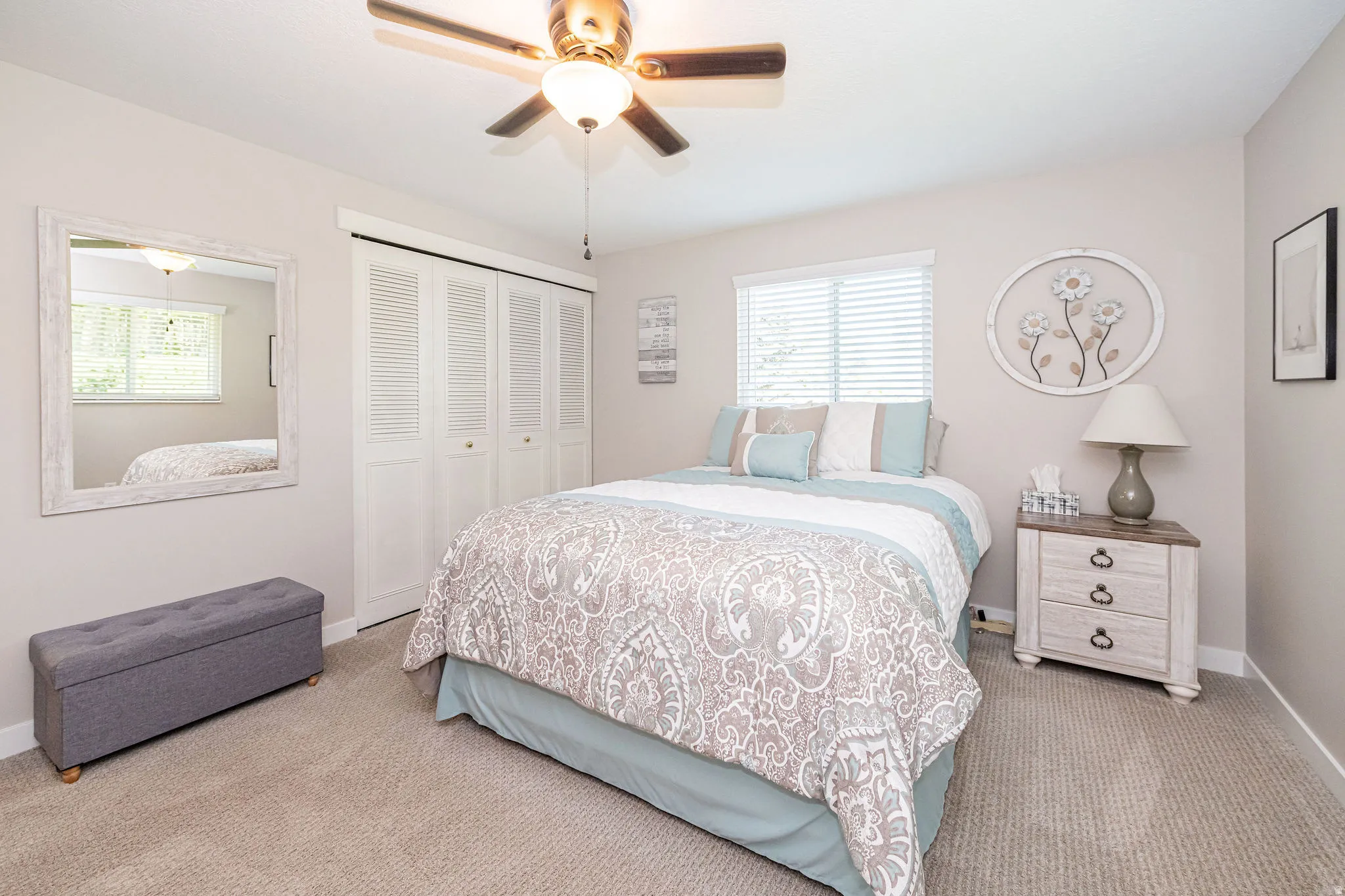 Bedroom featuring a ceiling fan, a closet, and carpet flooring