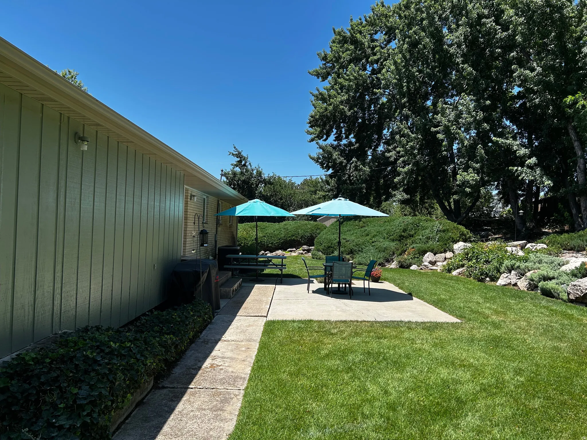 View of green lawn featuring a patio area