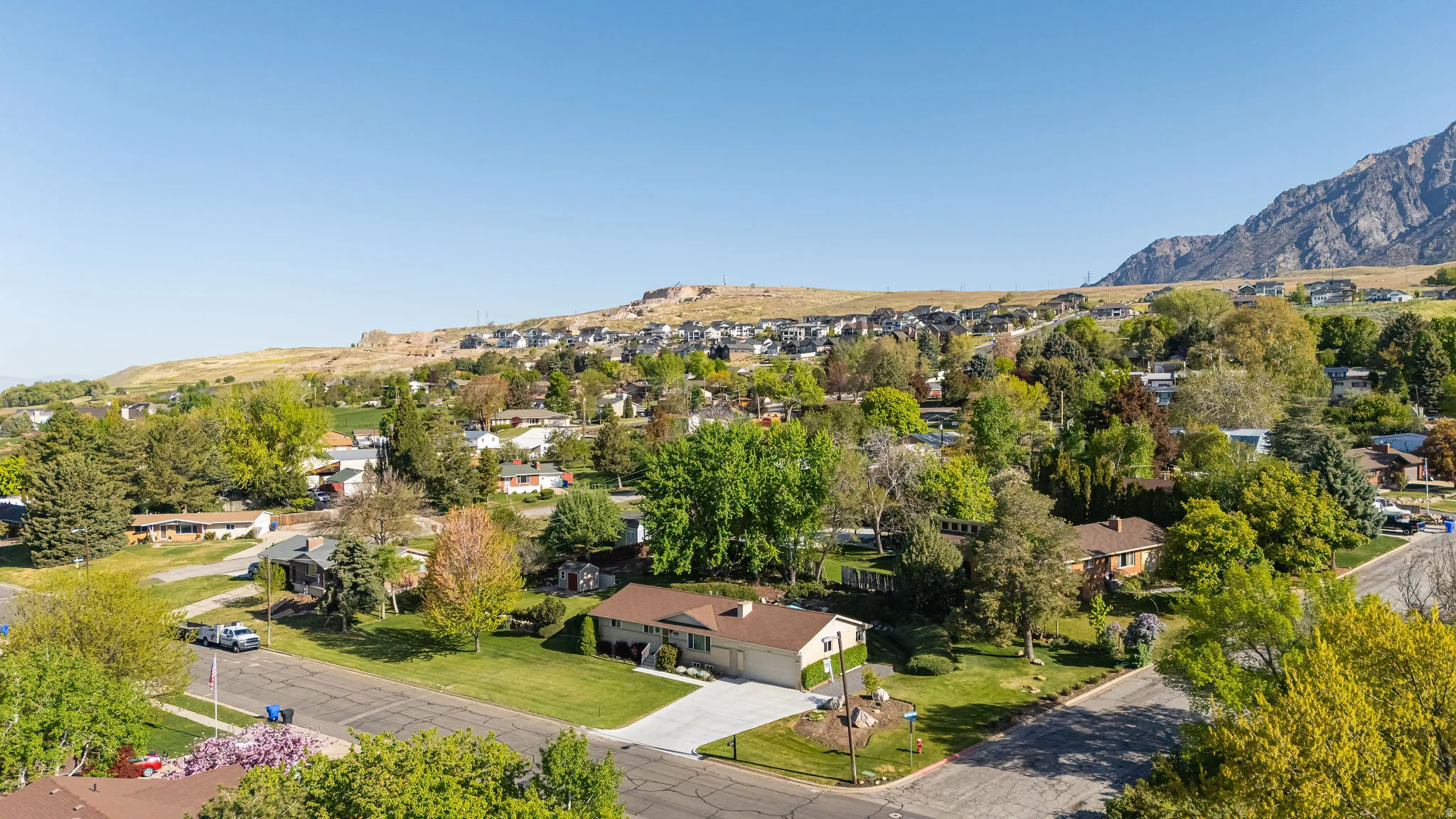 Aerial perspective of suburban area with a mountain backdrop