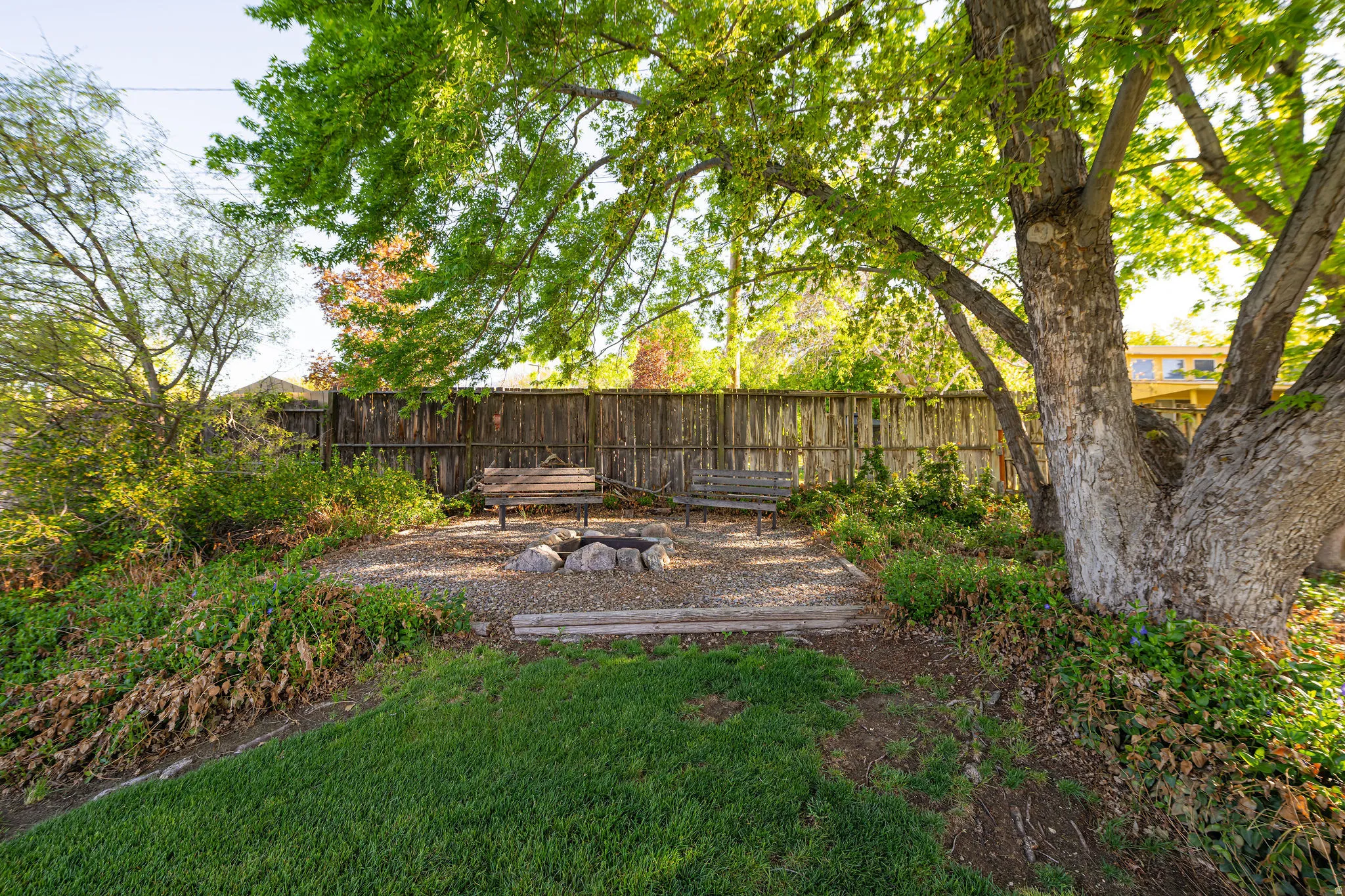 Fenced backyard featuring a patio and an outdoor fire pit