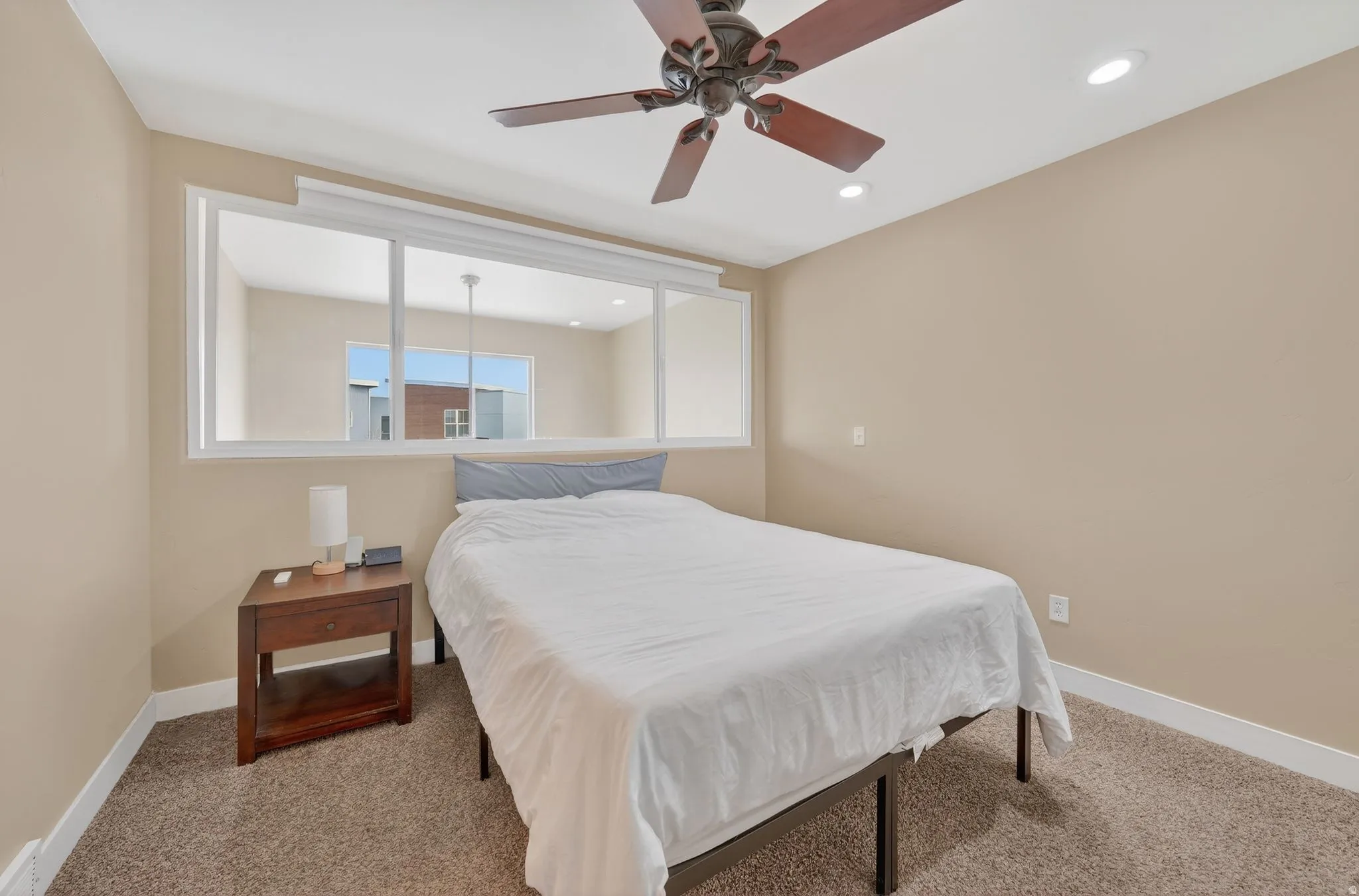 Bedroom featuring ceiling fan, light carpet, and recessed lighting