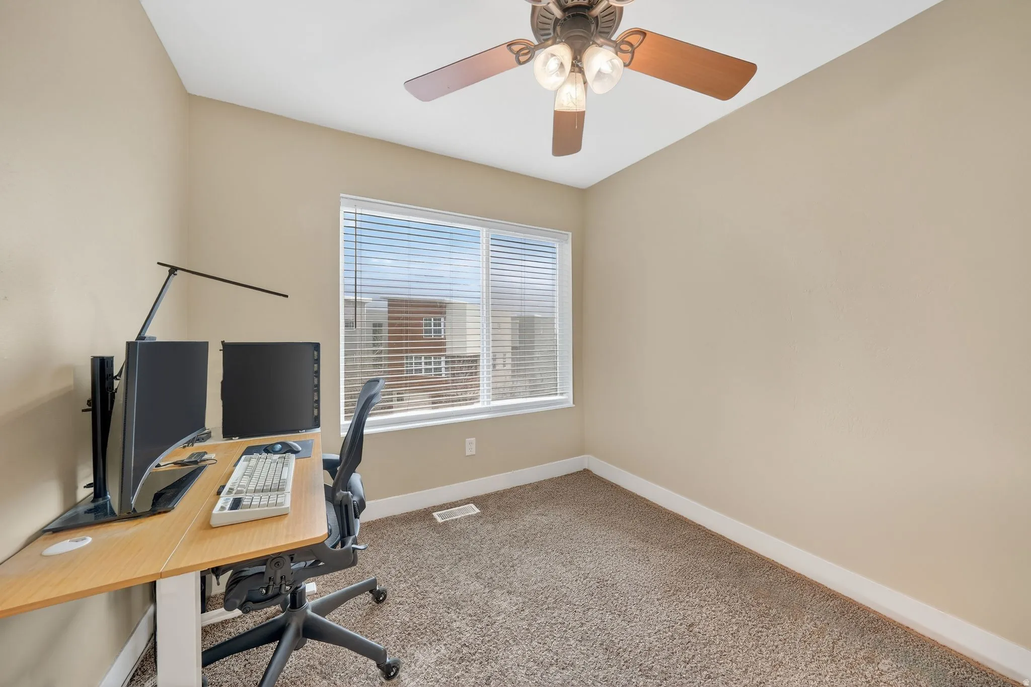 Carpeted office featuring baseboards