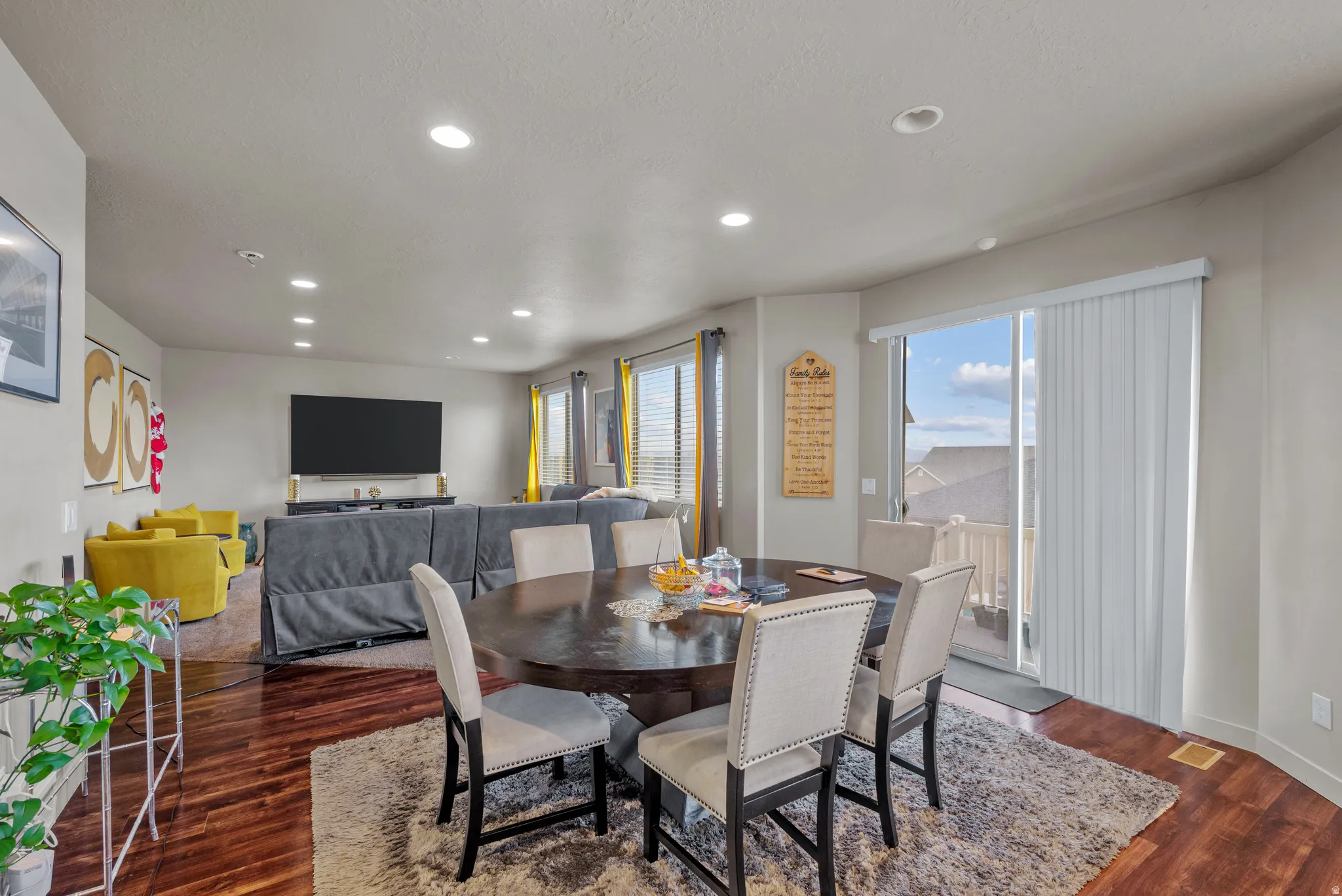 Dining space featuring dark wood-style floors and recessed lighting