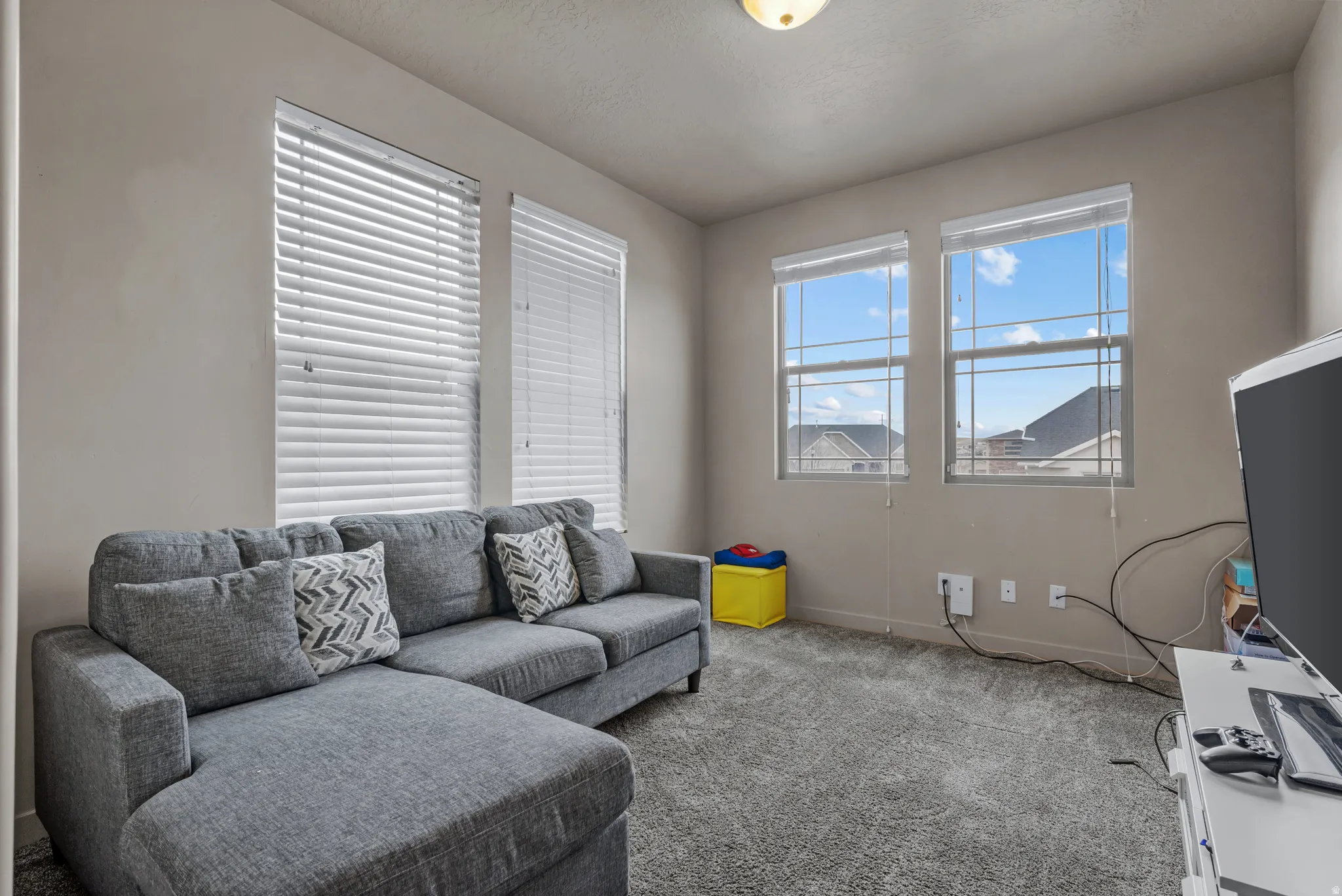 Carpeted living area with baseboards