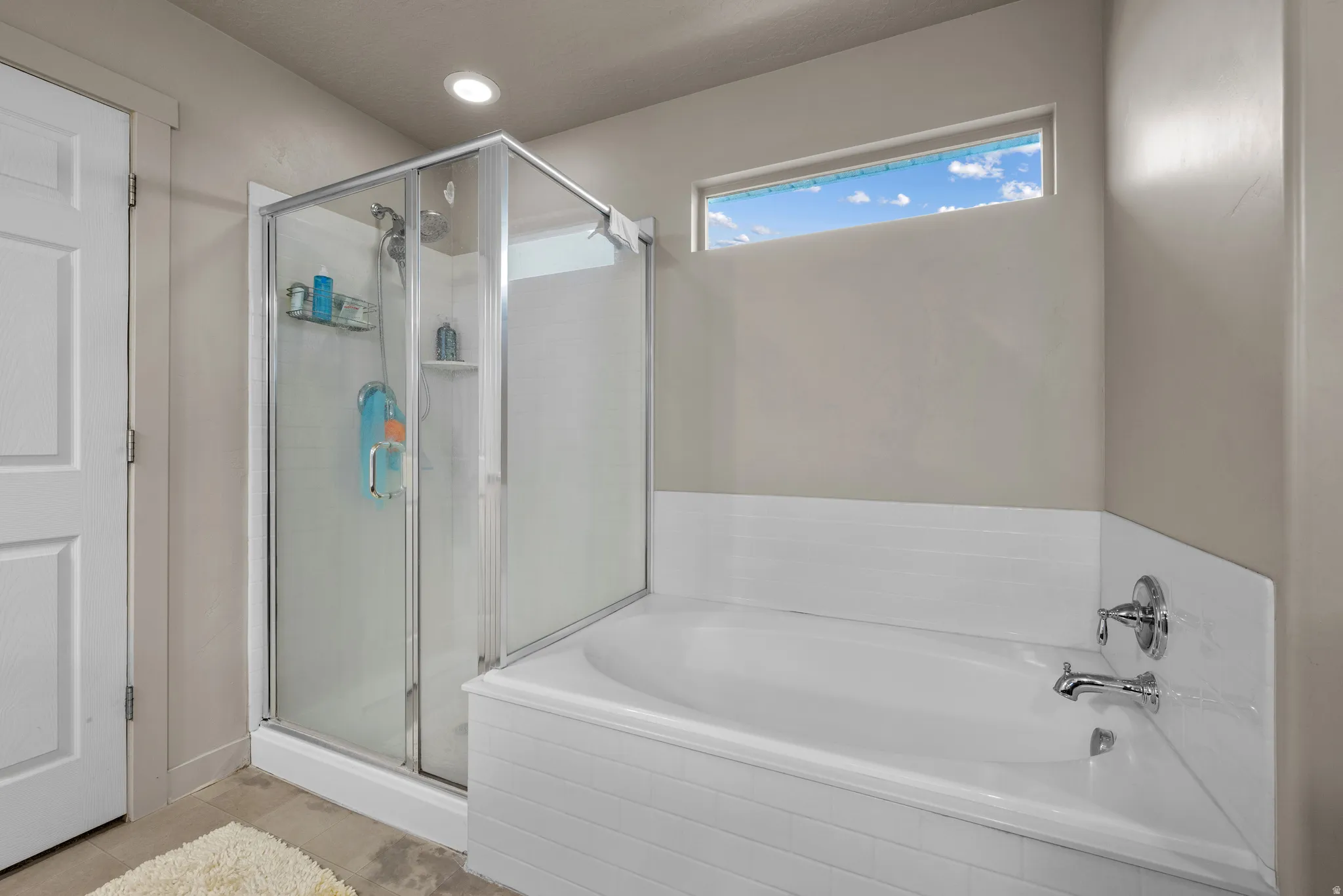 Bathroom with a garden tub and a stall shower