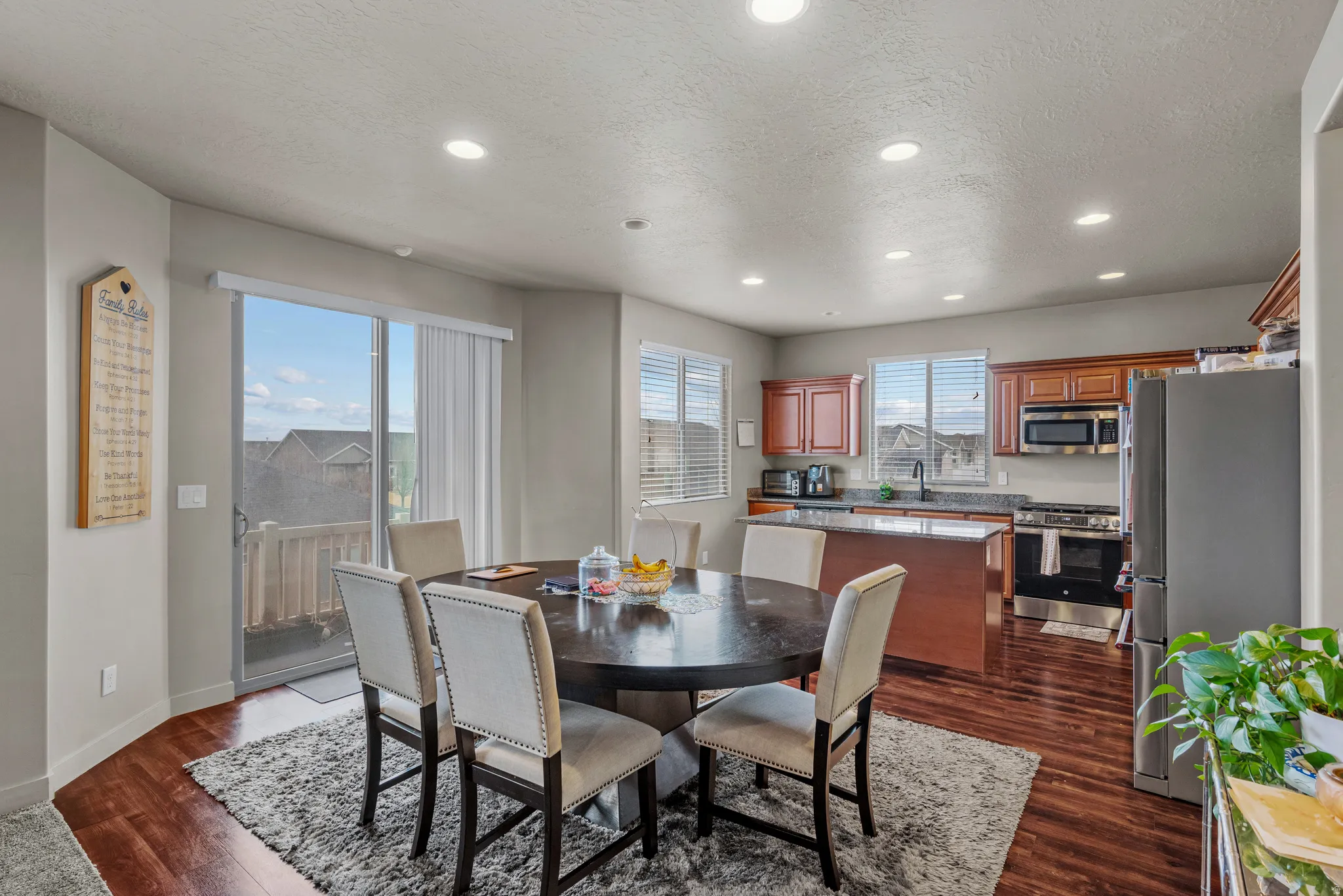 Dining space featuring recessed lighting, dark wood-type flooring, and a textured ceiling