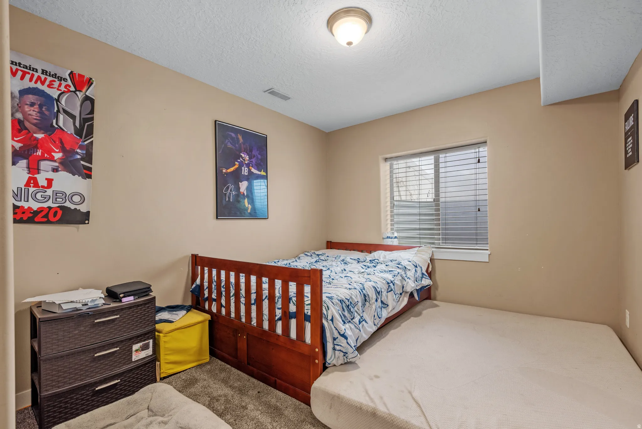 Bedroom featuring carpet floors and a textured ceiling